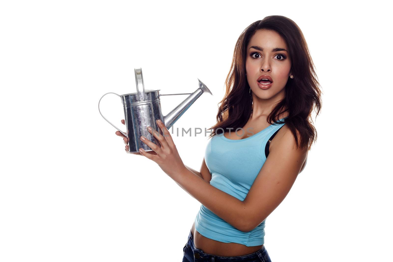 Beautiful and fashion young woman holding a watering can.