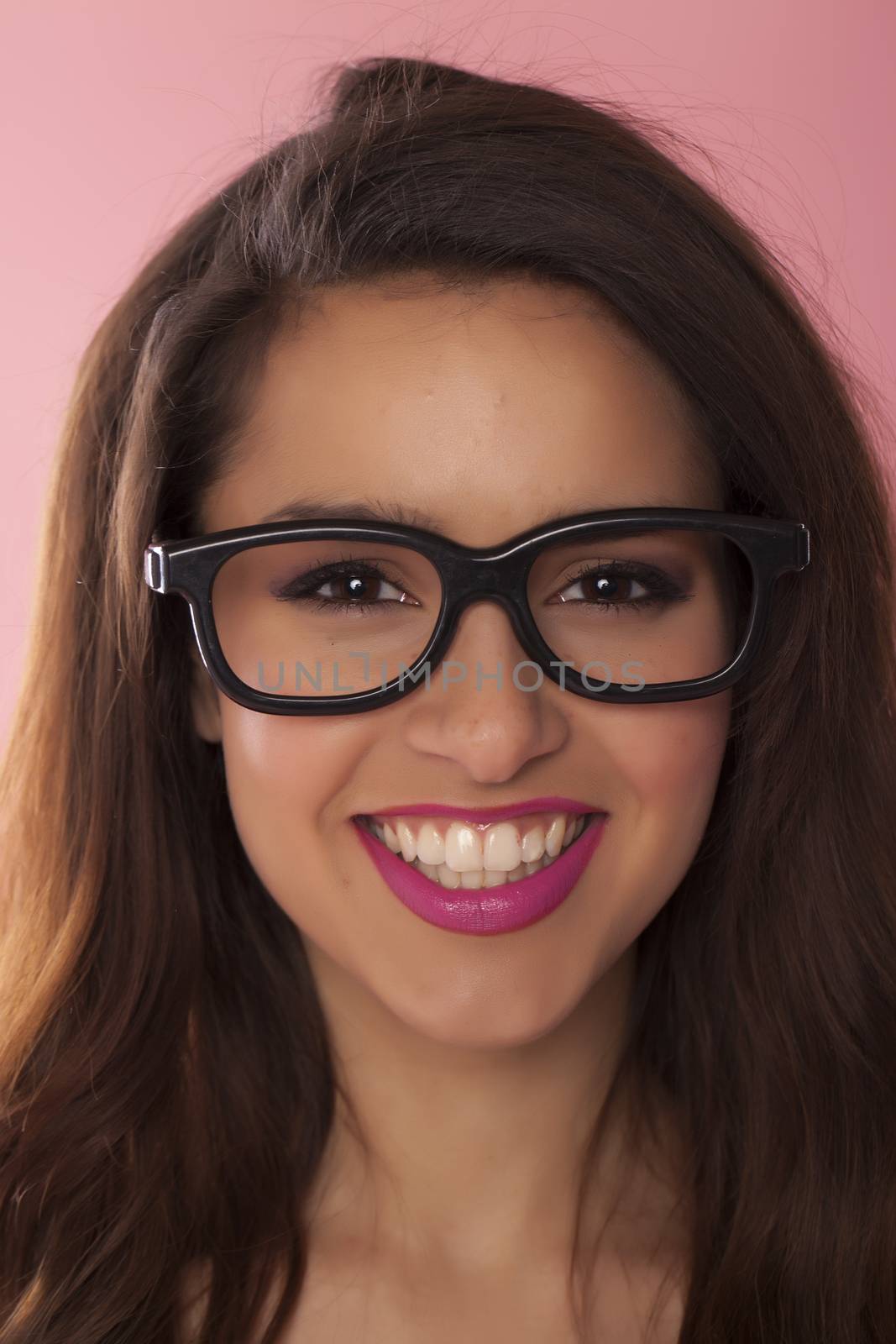 Beautiful casual woman over a pink background.