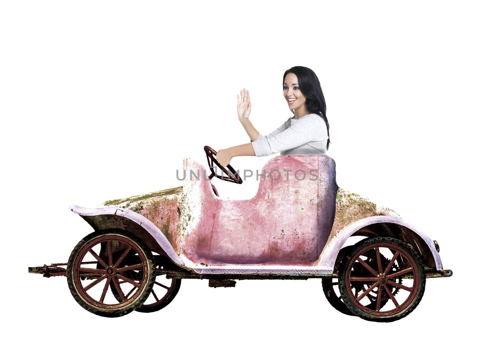 Woman in retro grunge toy car over a white background.