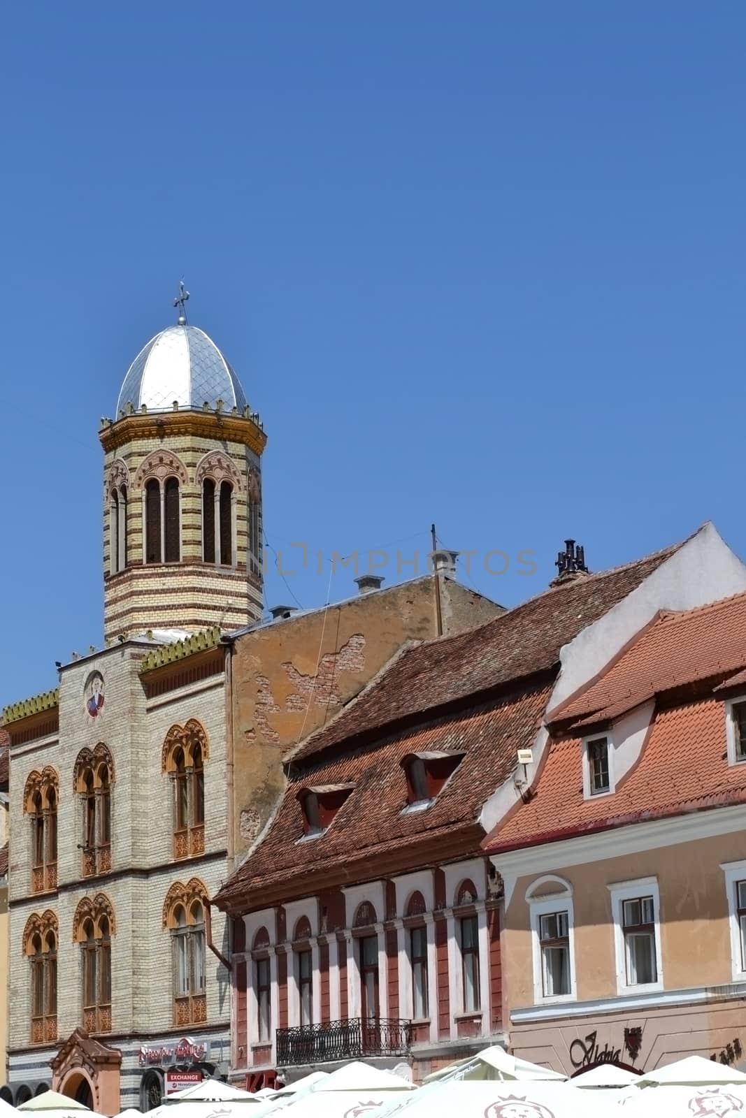 Churches, gates, towers, walls, buildings and ancient streets in downtown Brasov. Old windows, plaster slab, archways, green tourists