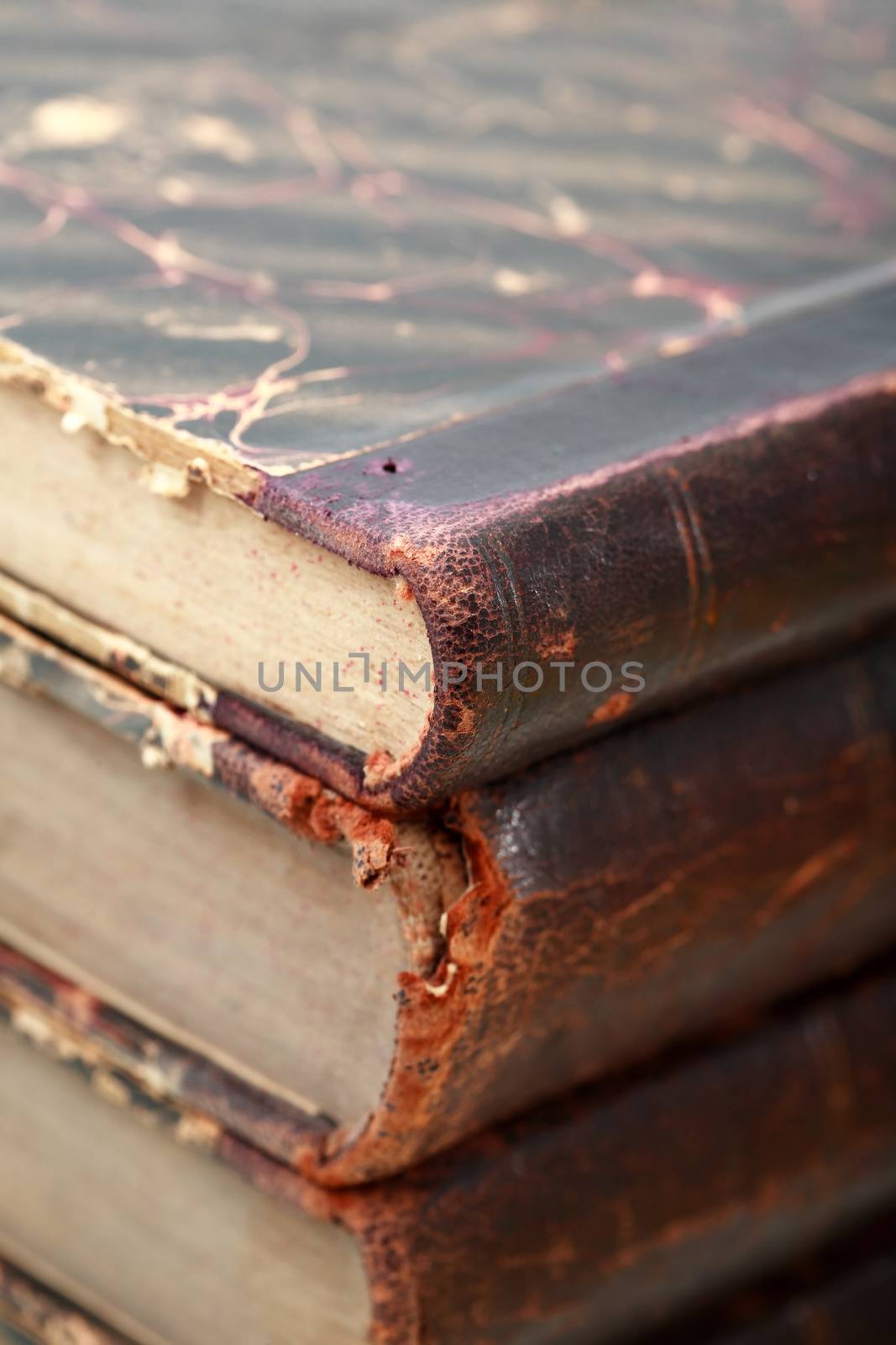 Extreme closeup of stack of few very old books as background