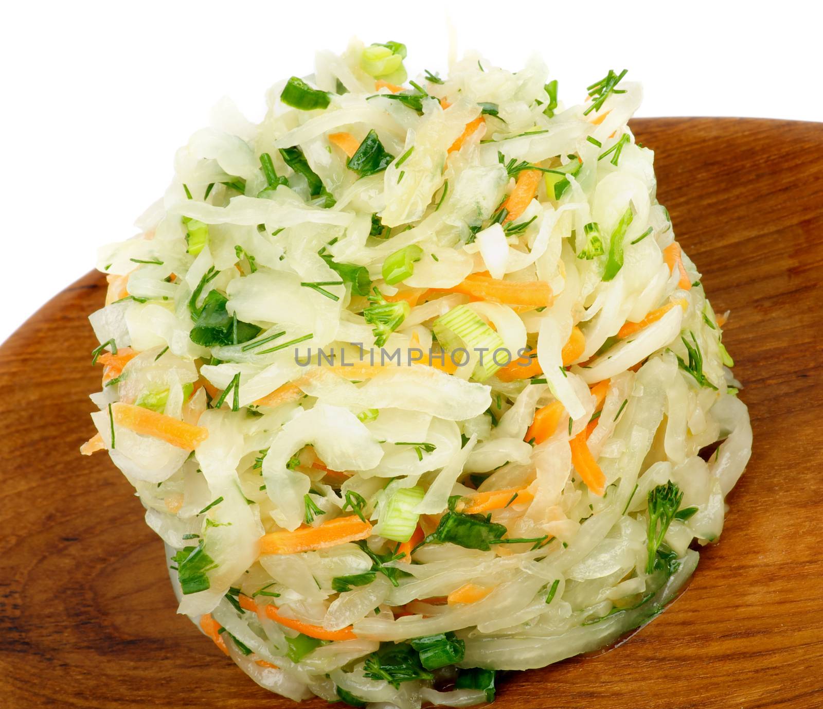 Delicious Salad with Sauerkraut, Spring Onion, Dill and Carrot on Wooden Plate closeup on White background