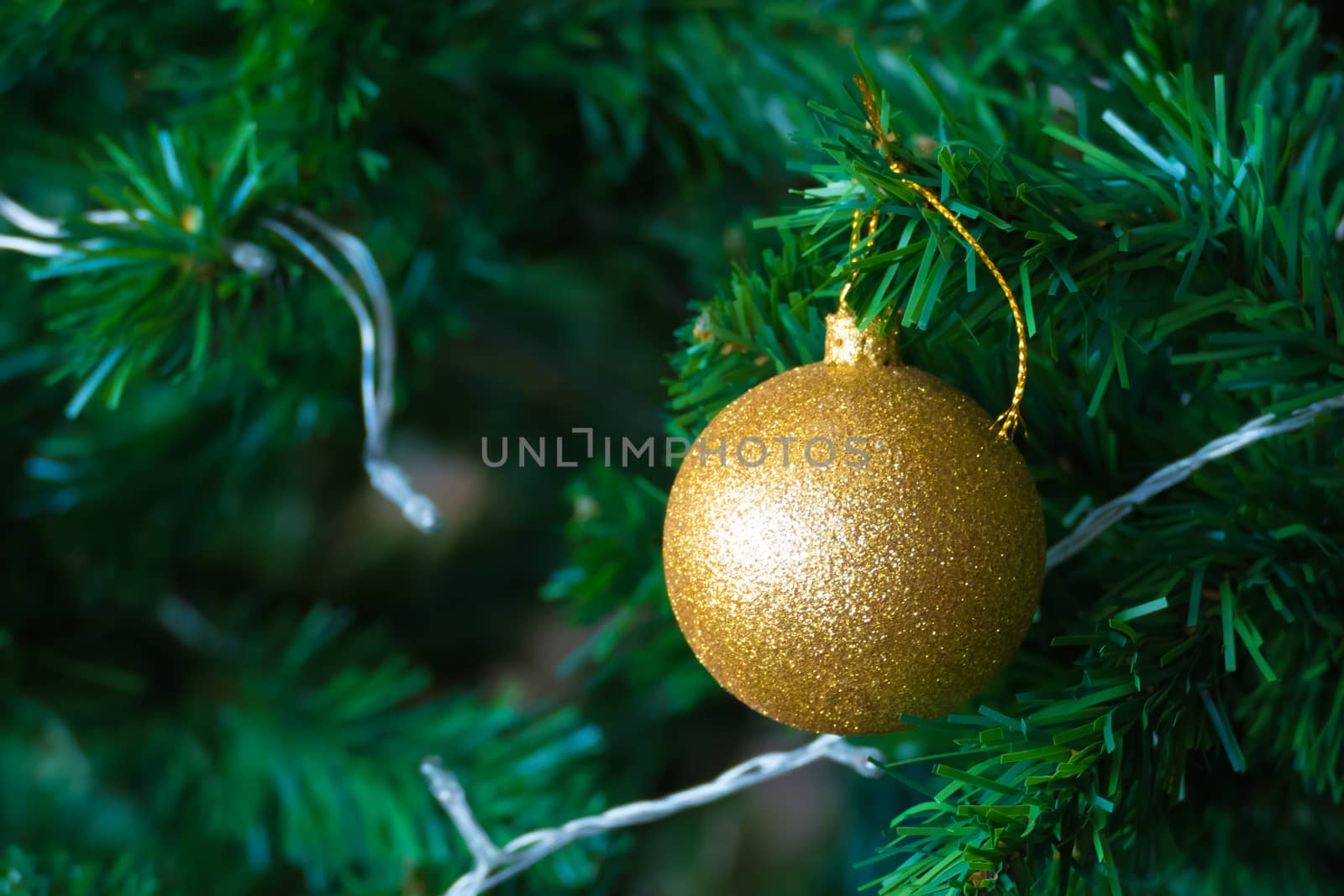 Gold Christmas background of de-focused lights with decorated tr by teerawit