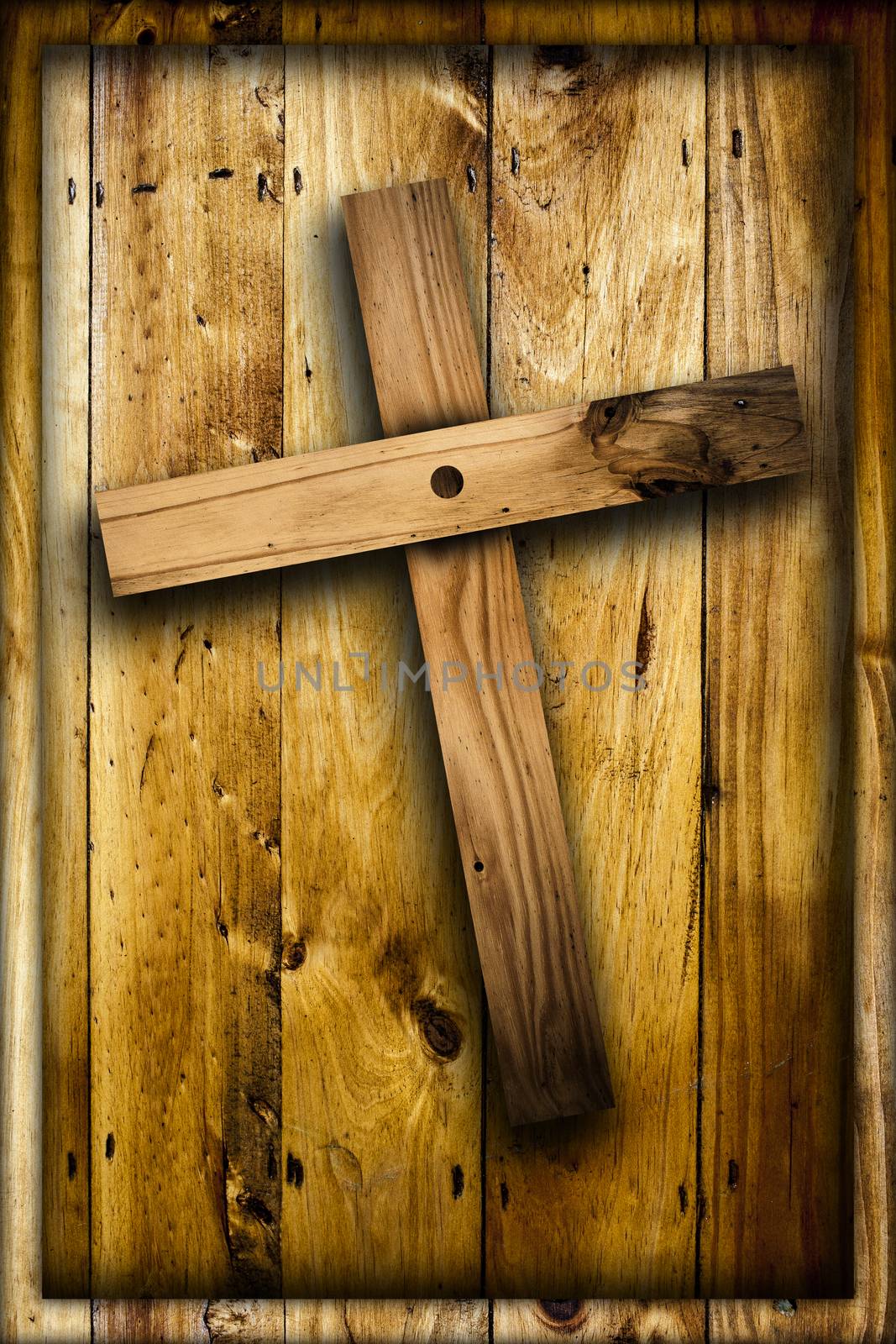 Cross on wooden background.
