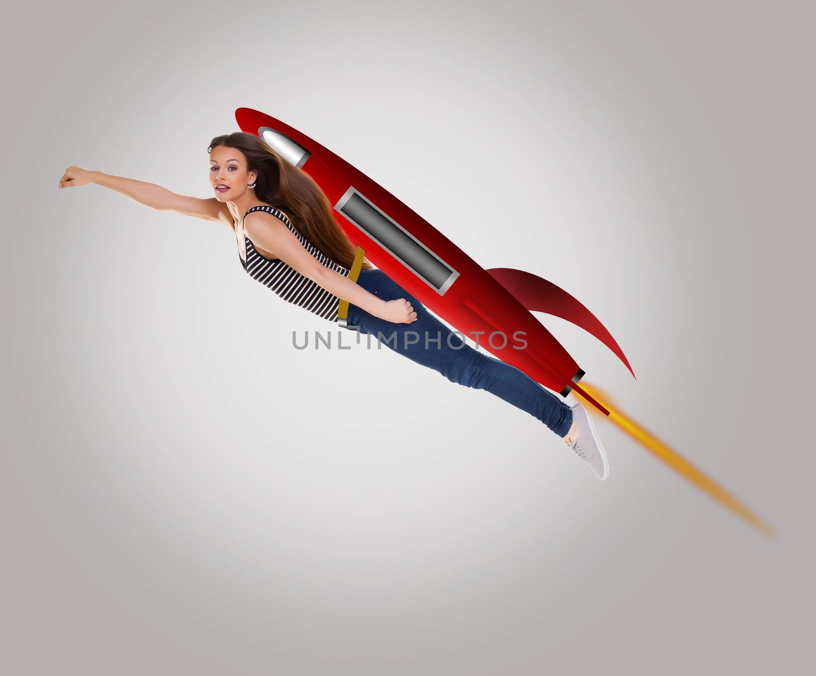 Young happy woman riding drawing a cartoon rocket.