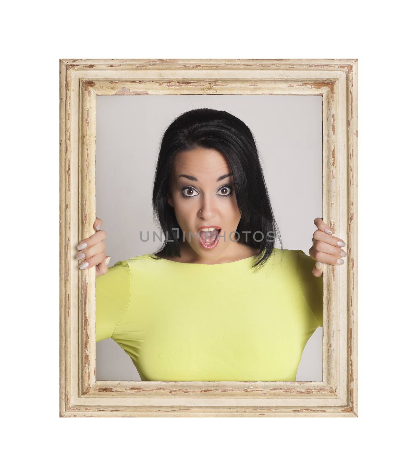 Abstract image of a beautiful woman trapped in a picture frame and making funny faces.