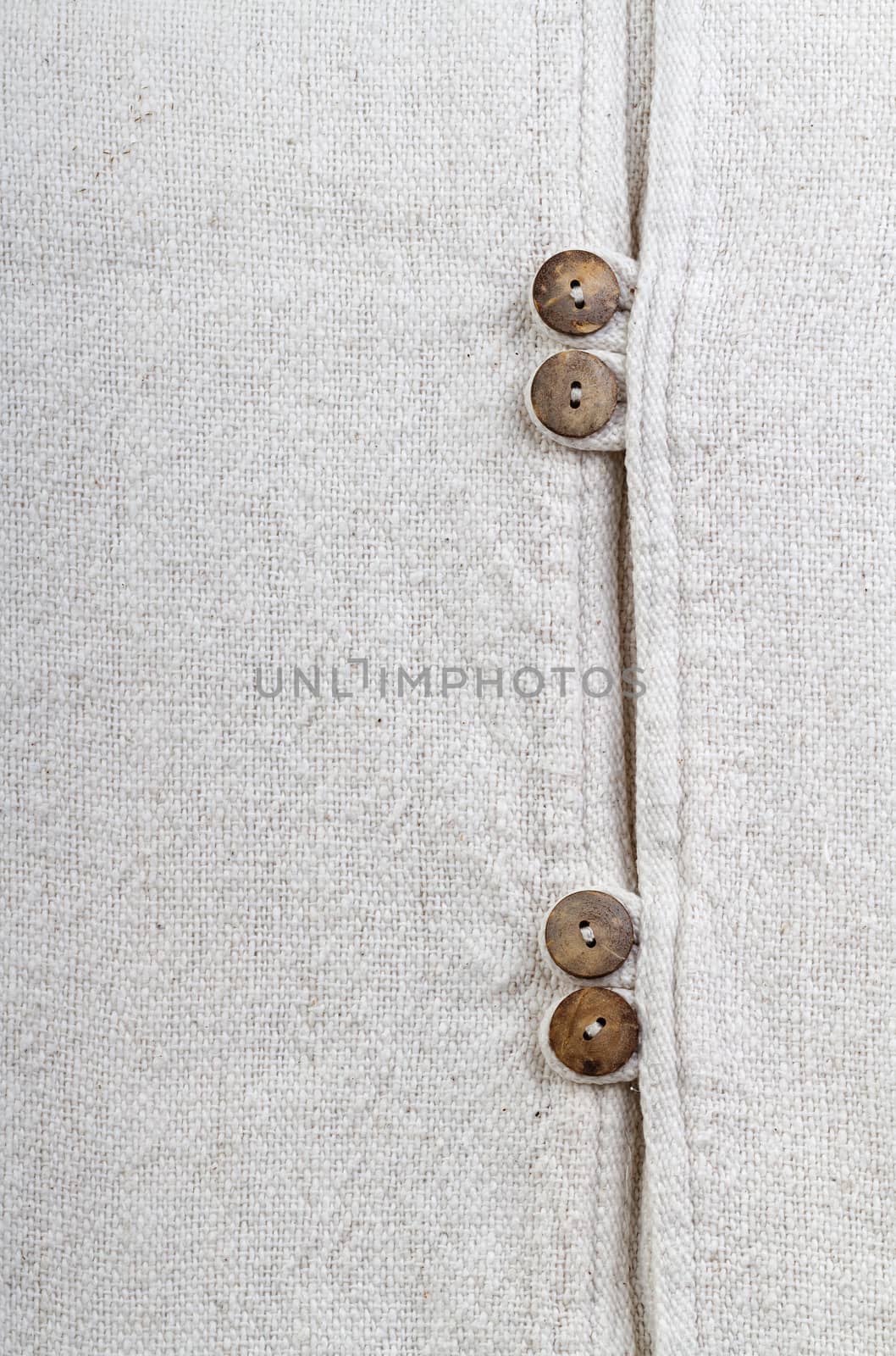 Closed up natural texture cotton fabric with wooden buttons