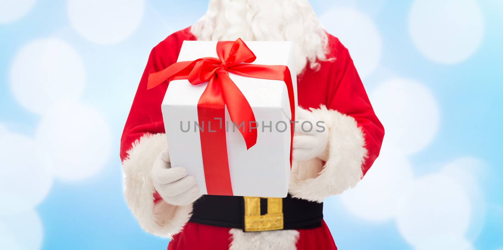 close up of santa claus with gift box by dolgachov