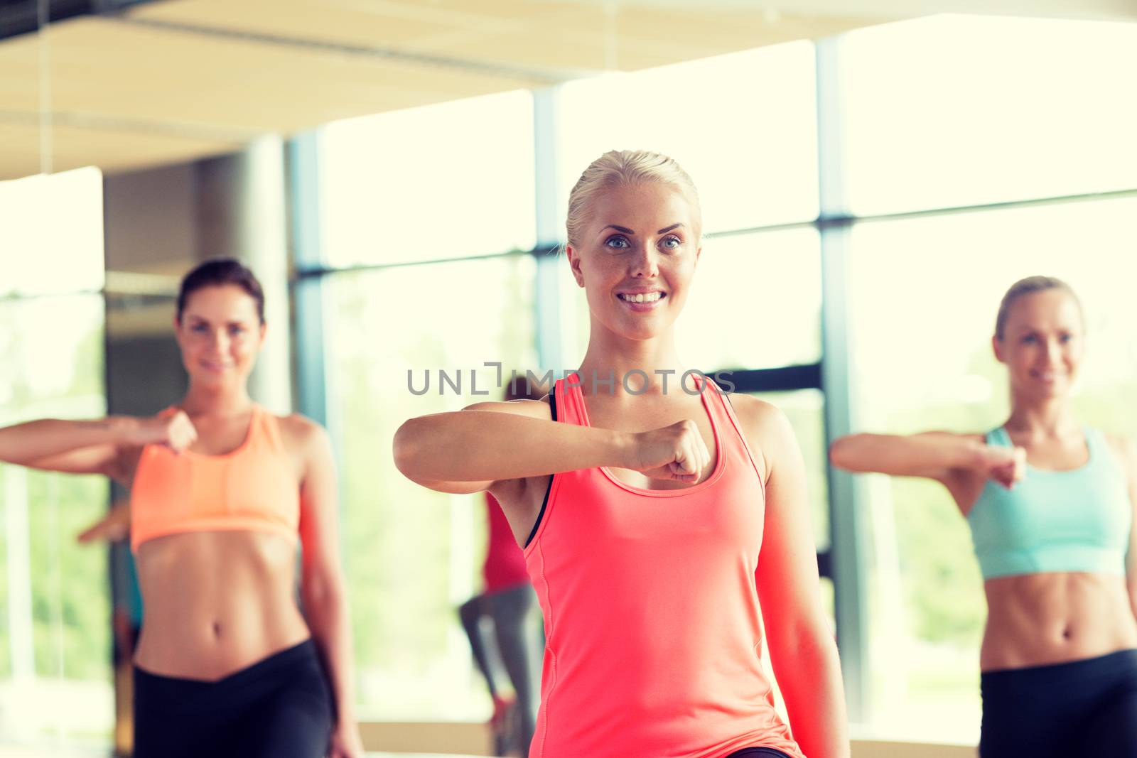 fitness, sport, training, gym and lifestyle concept - group of women working out in gym