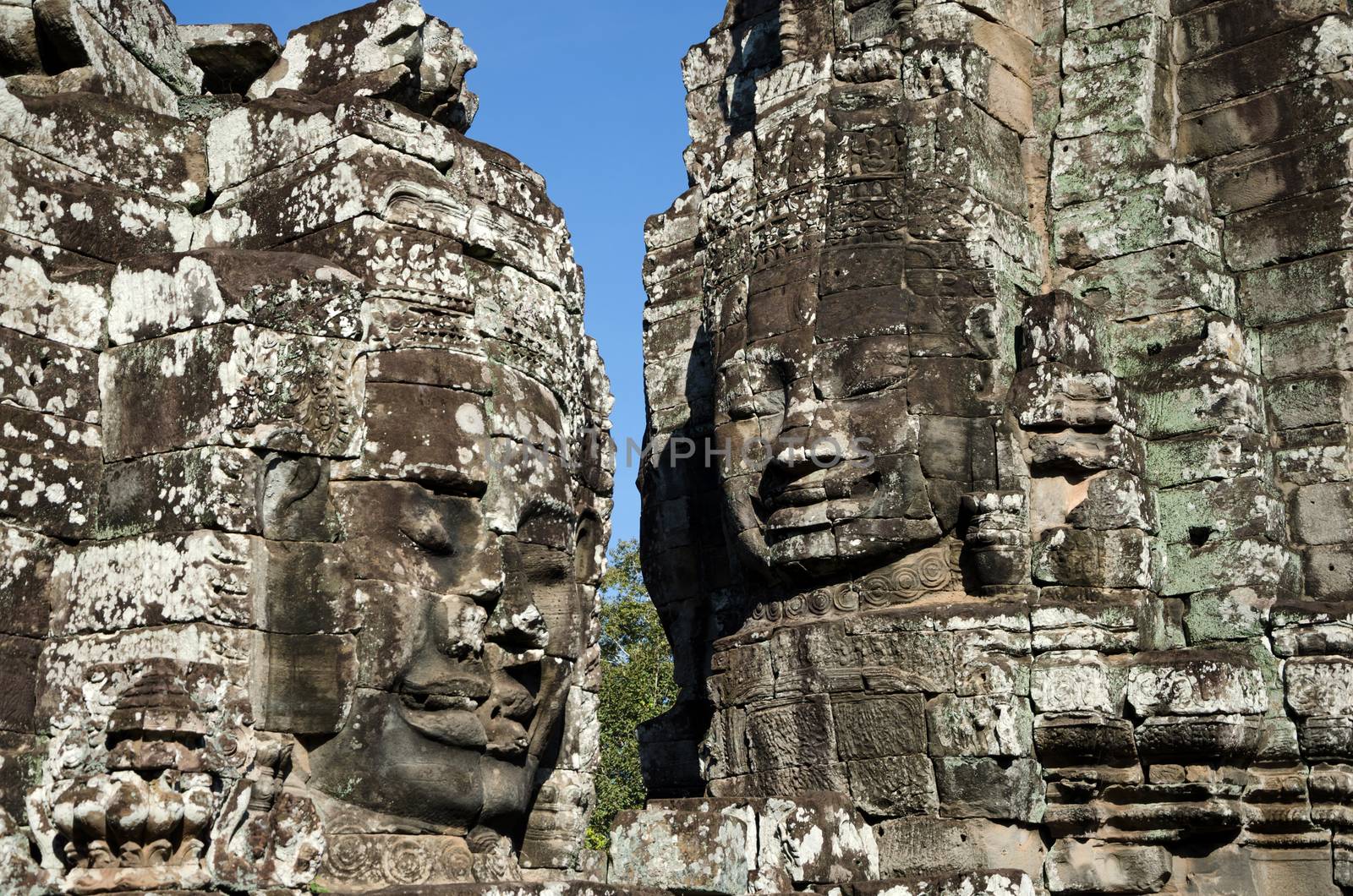 Faces of Bayon temple in Angkor Thom by siraanamwong