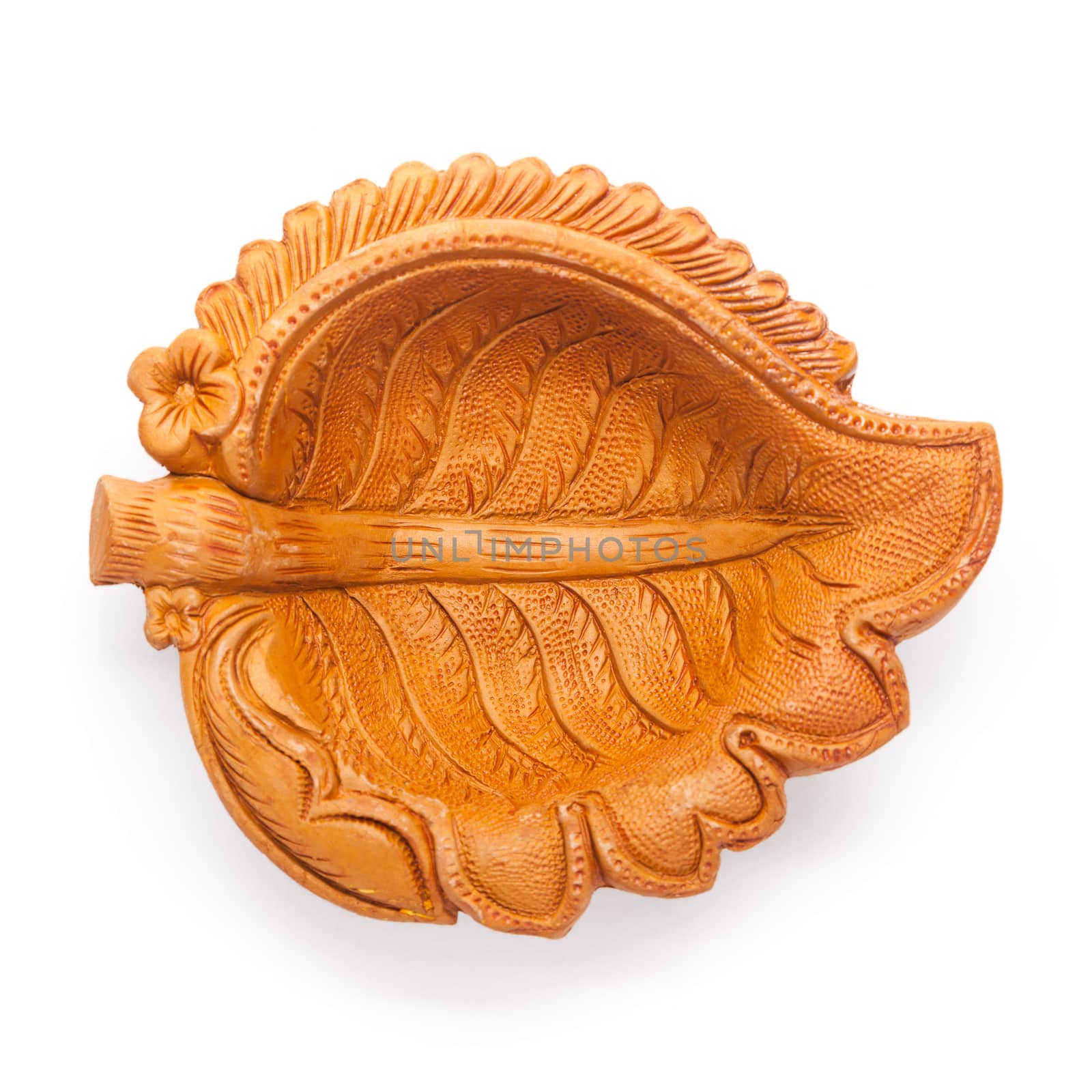 Top view of a beautifully carved leaf design handmade clay lamp isolated on white background.