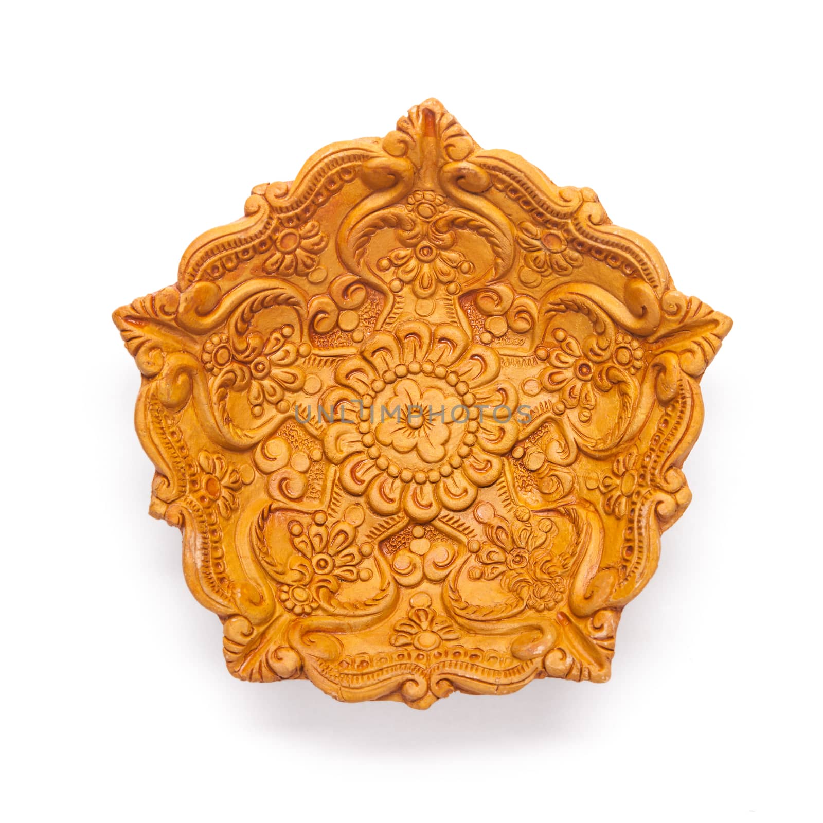 Top view of a beautifully carved designer handmade clay lamp isolated on white background.