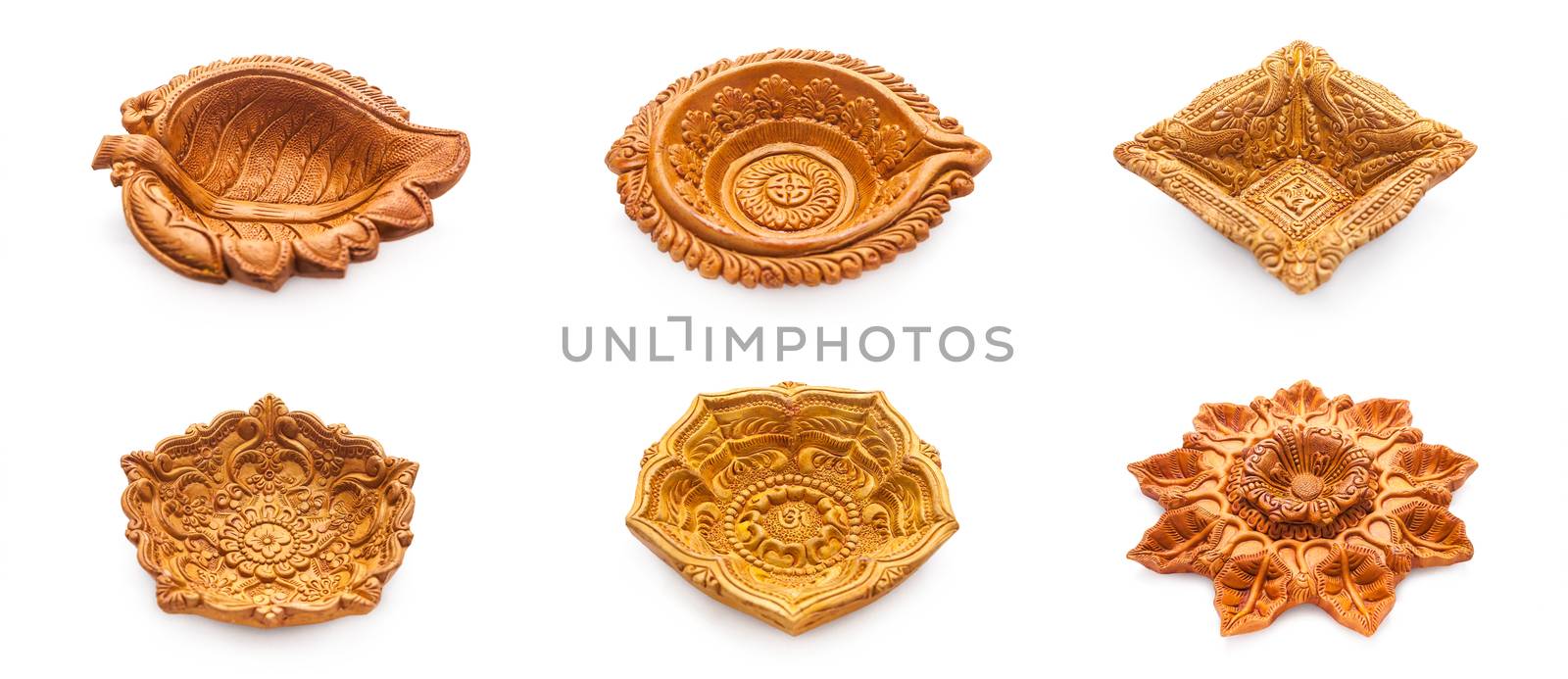 Front view Collage of beautifully carved designer different types of handmade clay lamps isolated on white background.