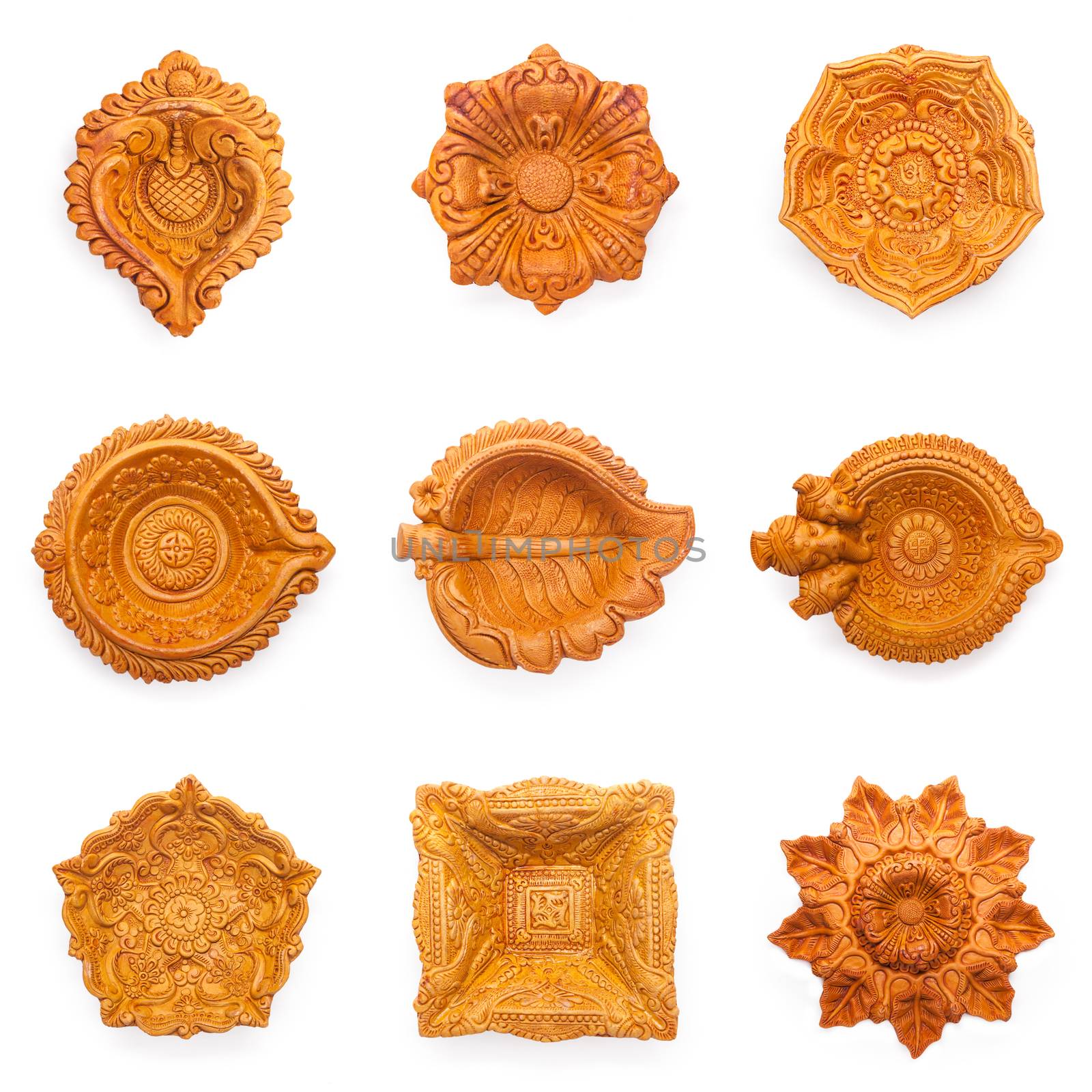 Top view Collage of beautifully carved designer different types of handmade clay lamps isolated on white background.
