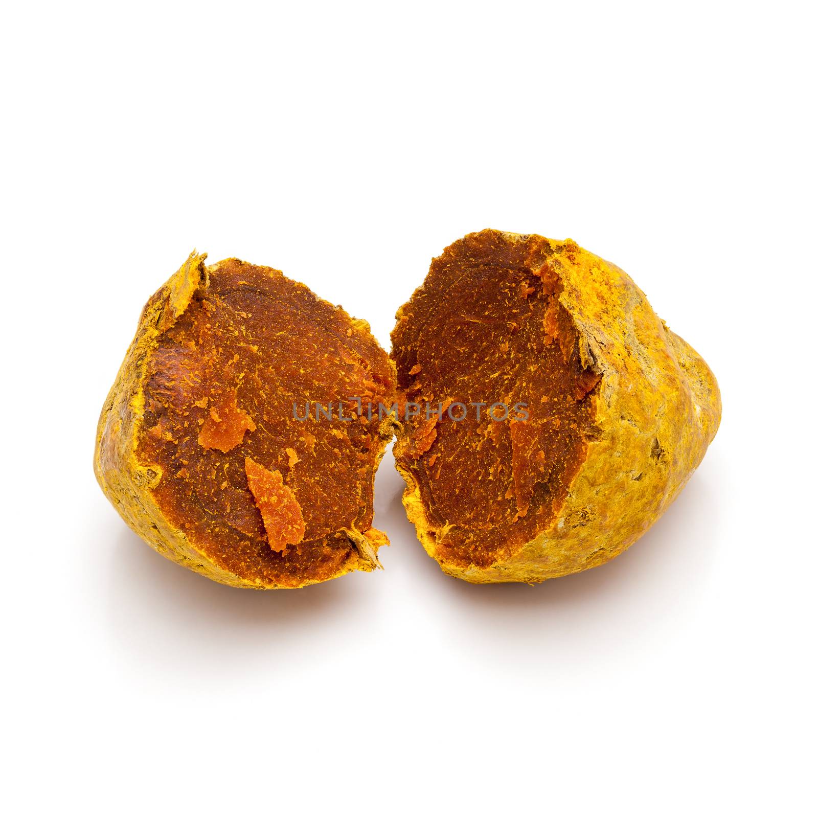 Macro closeup of a cracked Organic Round Turmeric or Haldi (Curcuma longa) isolated on white background.