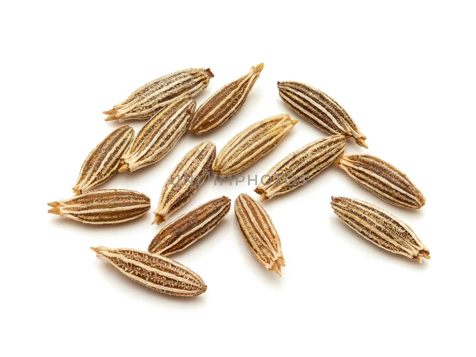 Macro closeup of Organic Cumin seeds (Cuminum cyminum) isolated on white background.