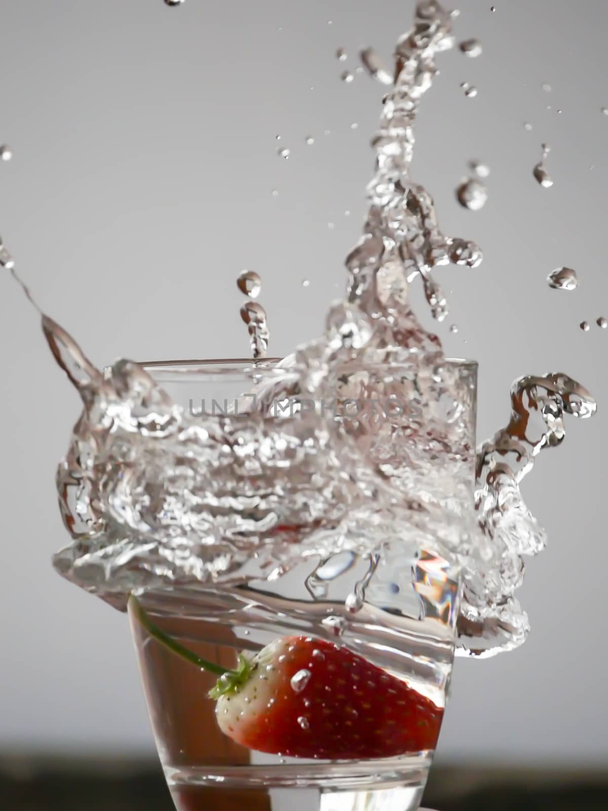 Strawberry Water splash in glass by nikky1972