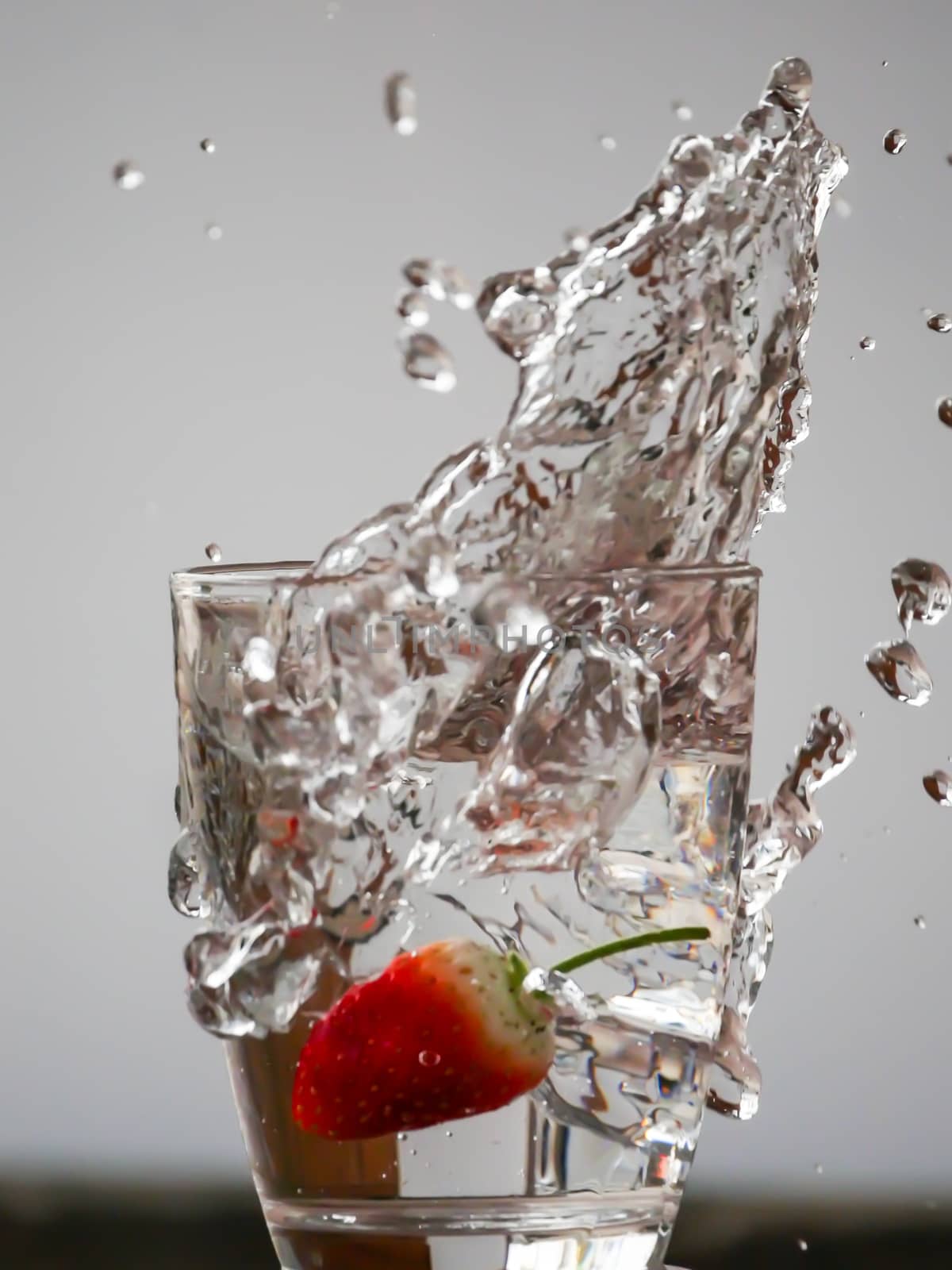 Strawberry Water splash in glass by nikky1972