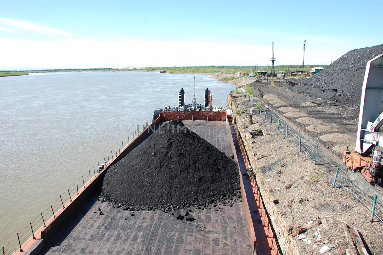 Barge with coal at river port Kolyma by danemo