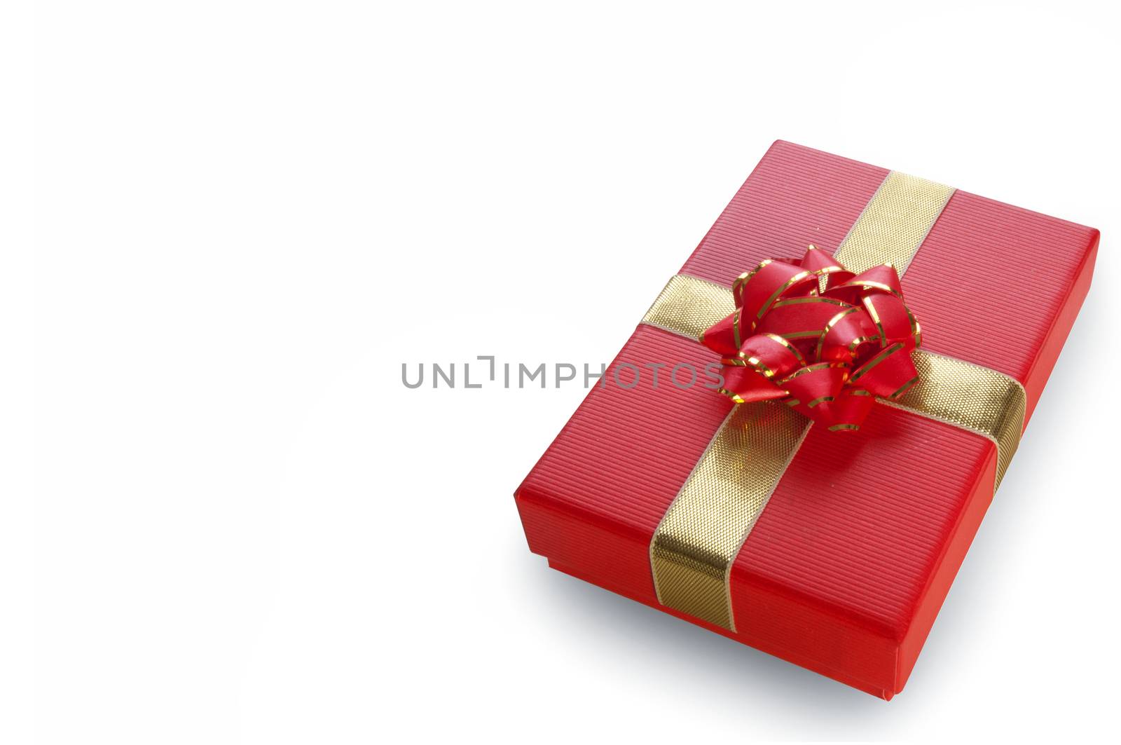 Red xmas gift box over a white background with space 