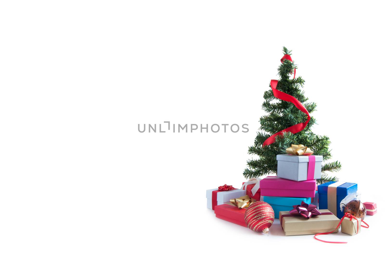 Many wrapped gift boxes around a christmas over a white background