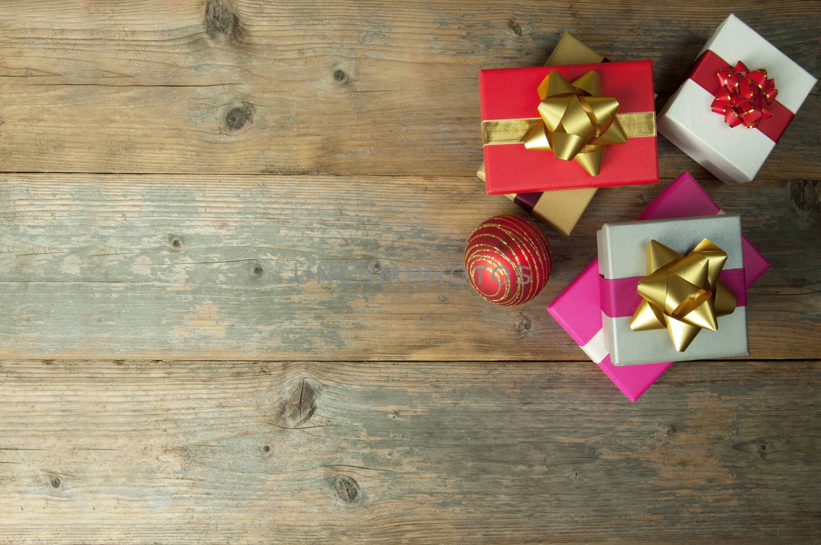 Christmas gifts over a wooden background with copyspace 