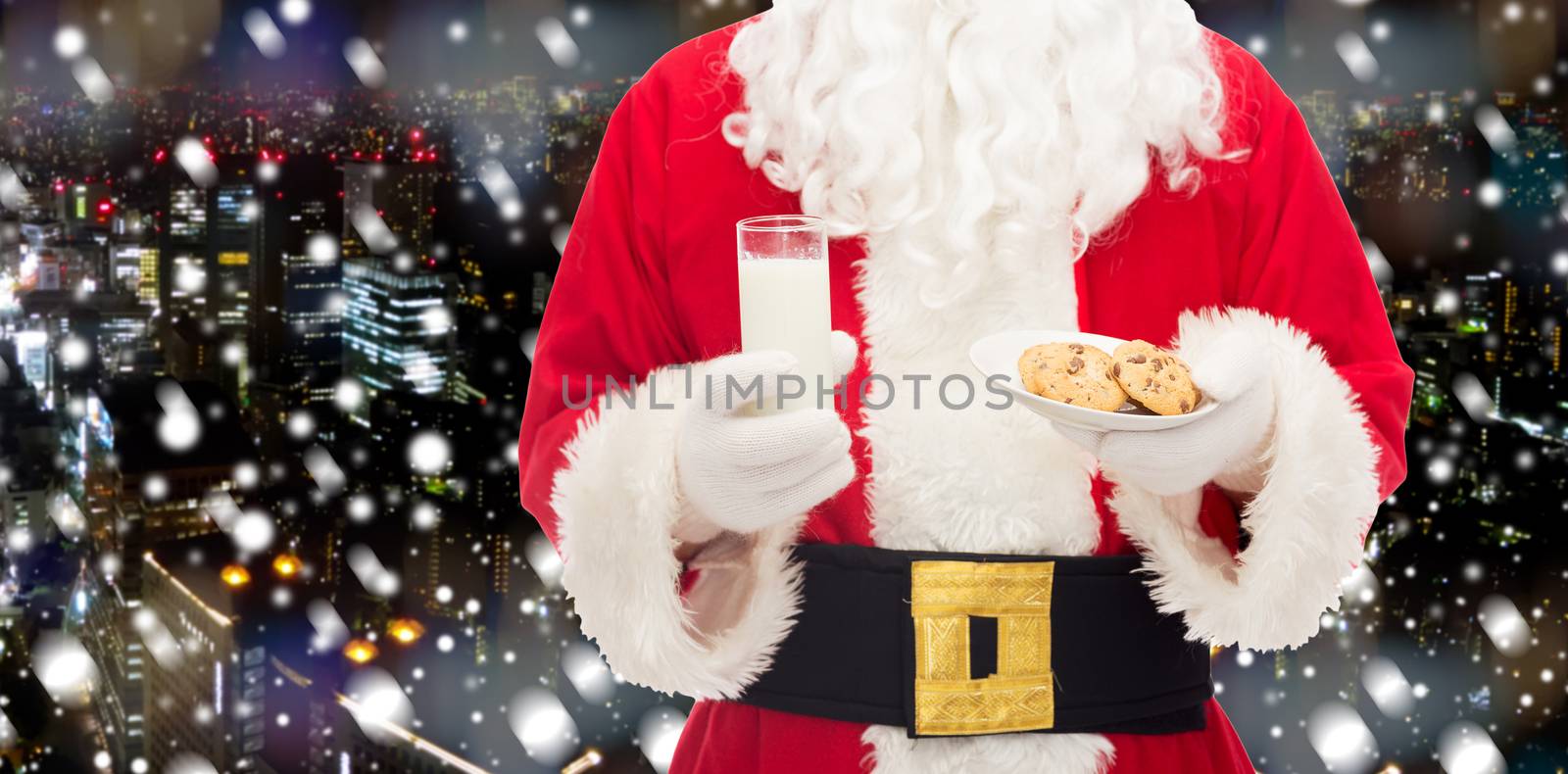 christmas, holidays, food, drink and people concept - close up of santa claus with glass of milk and cookies over snowy night city background