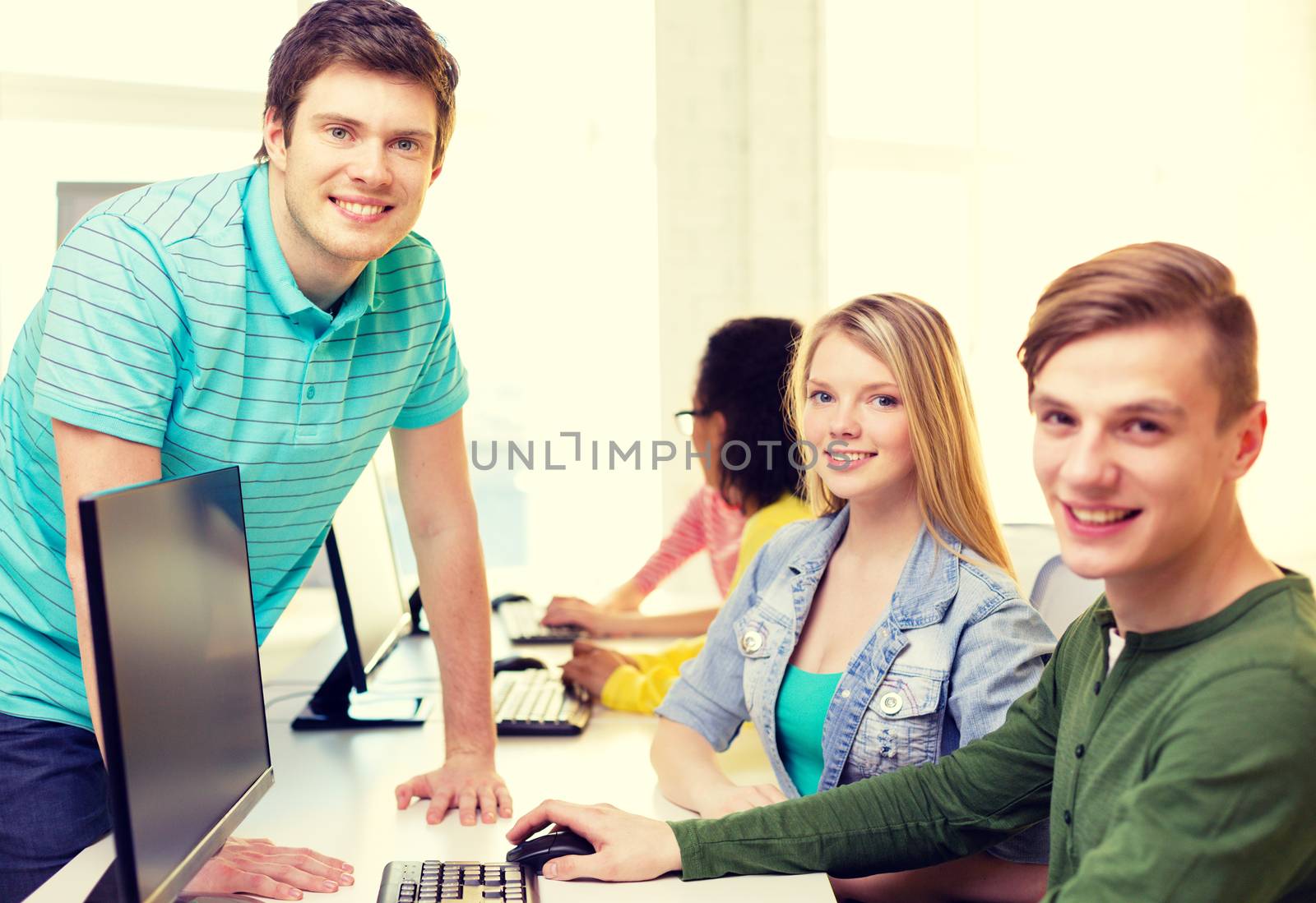 group of smiling students in computer class by dolgachov