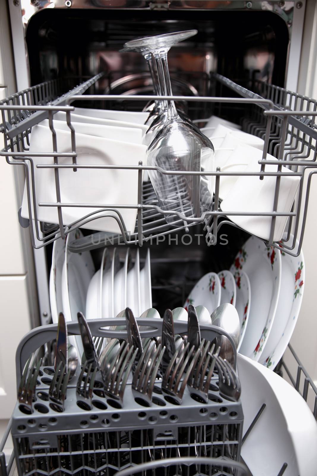 Open dishwasher with clean utensils