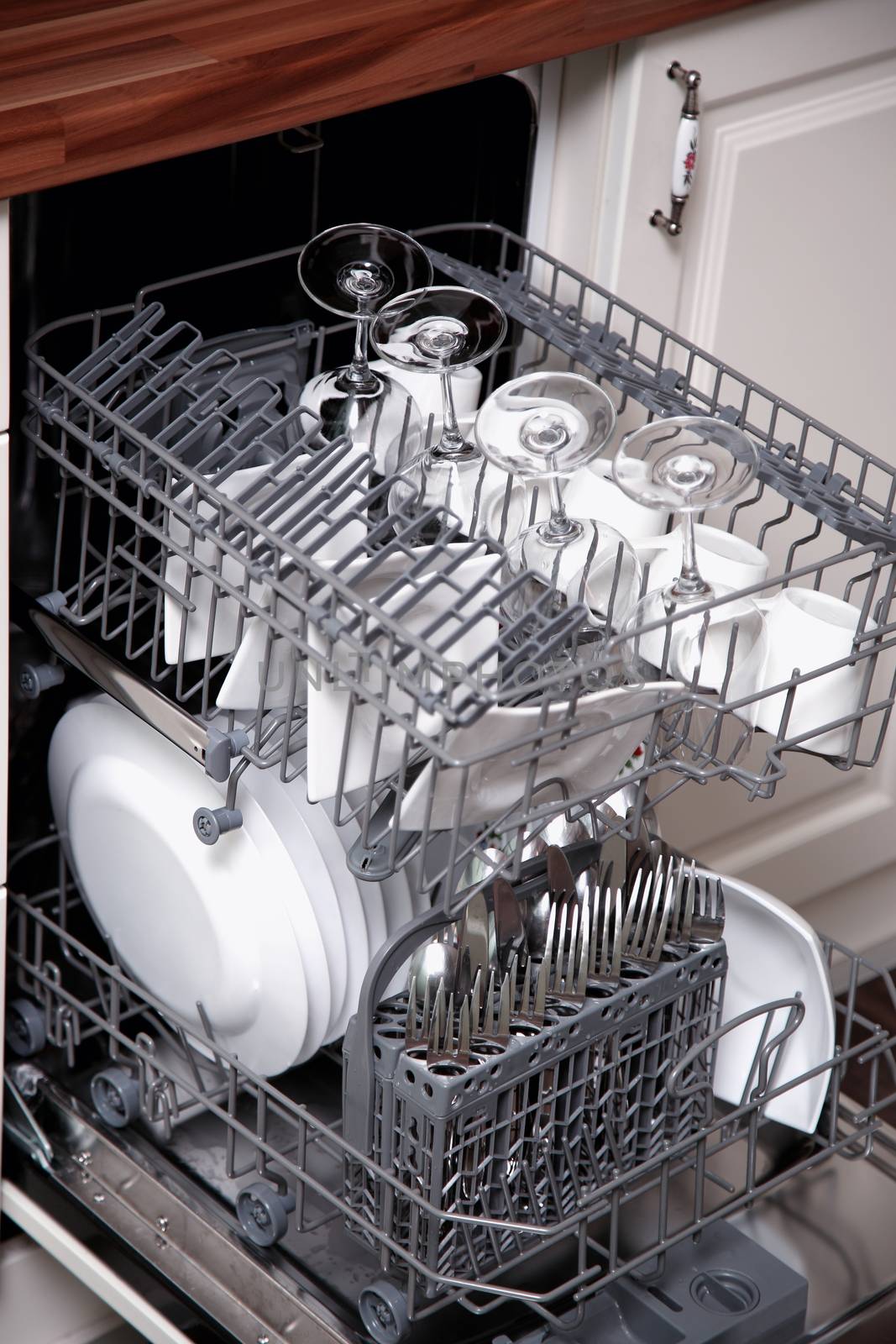 Open dishwasher with clean utensils