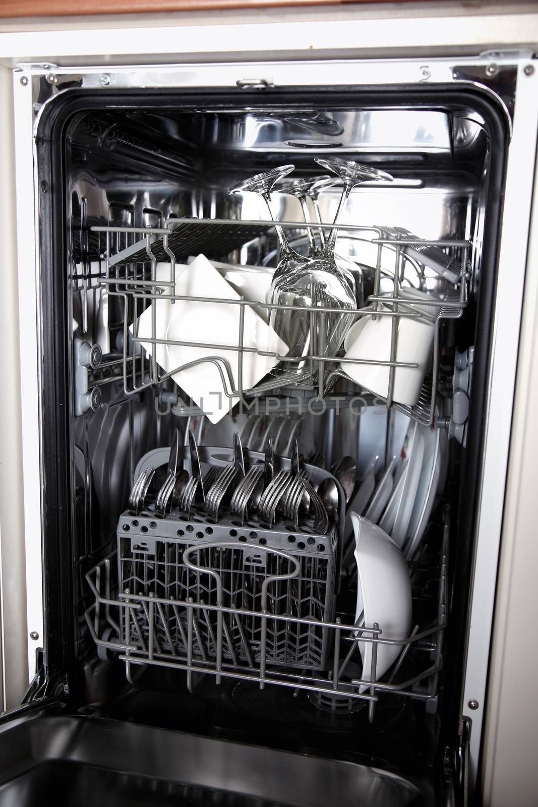 Open dishwasher with clean utensils by vladacanon