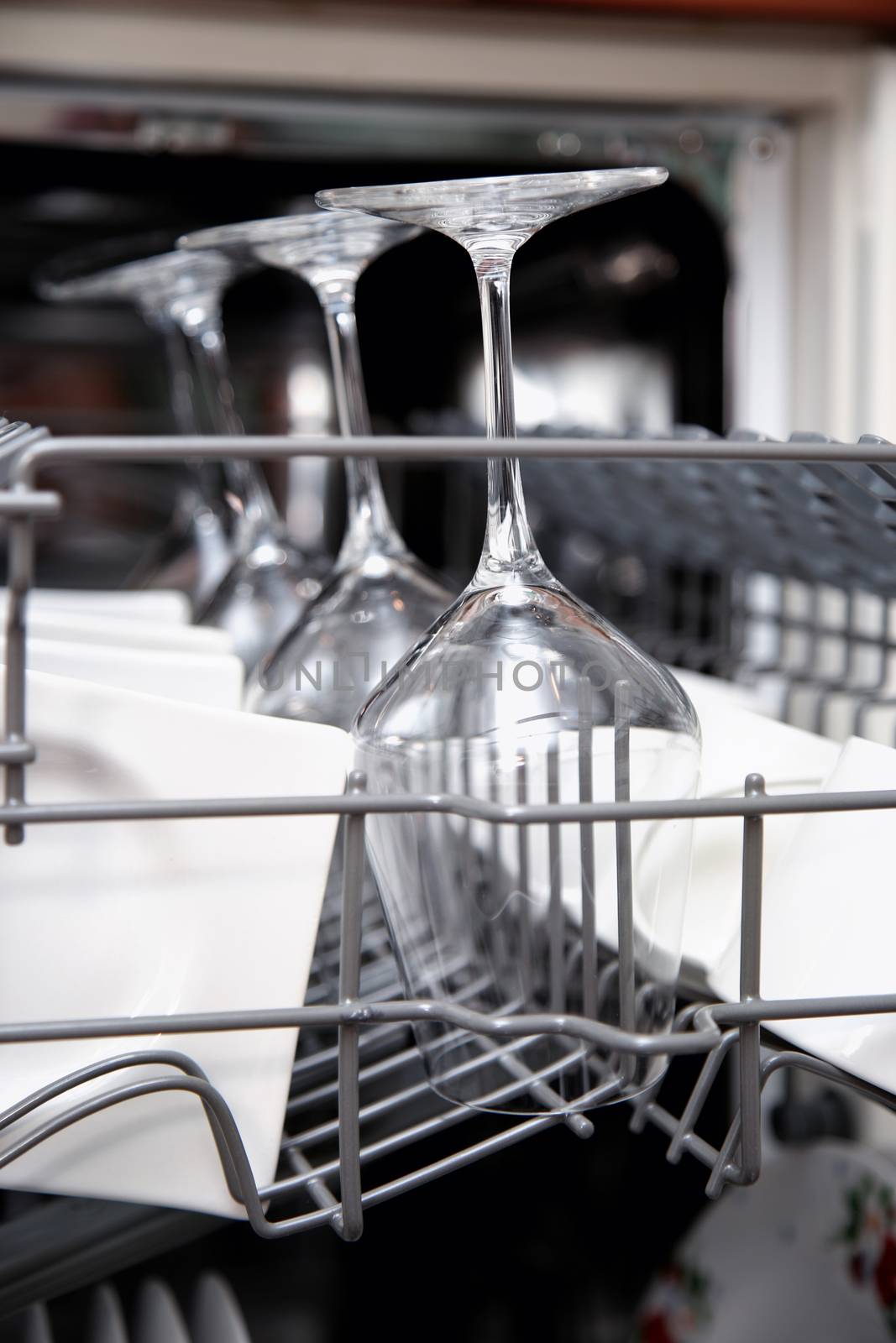 Open dishwasher with clean utensils by vladacanon