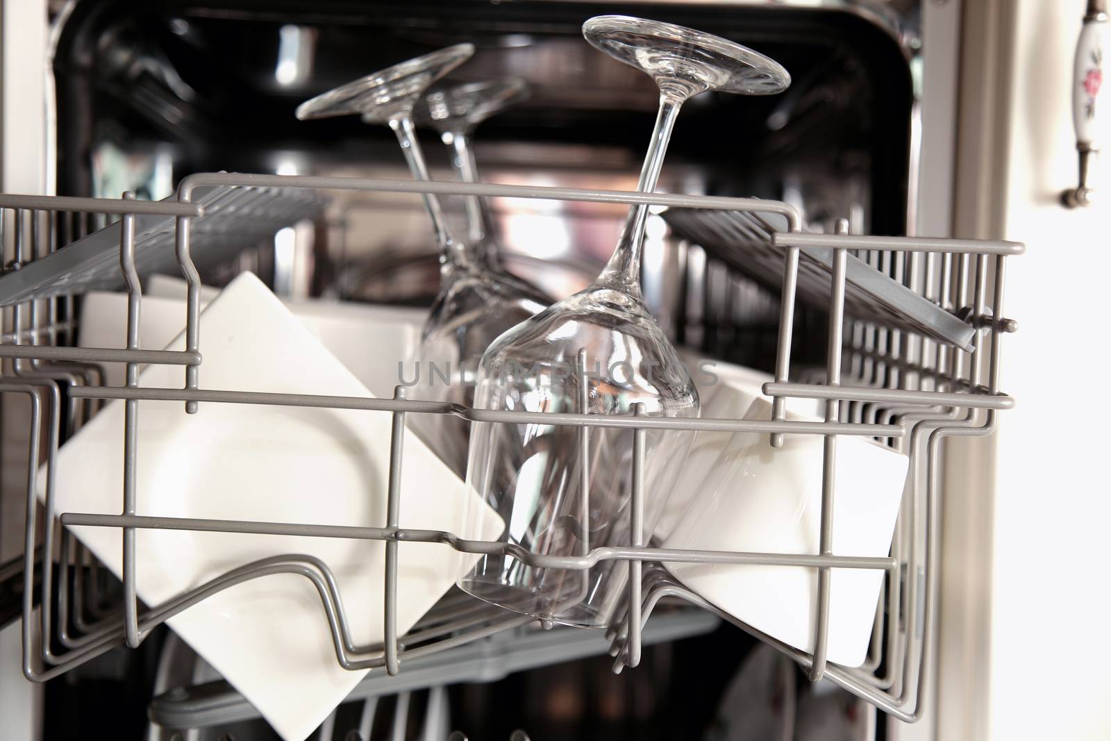 Open dishwasher with clean utensils