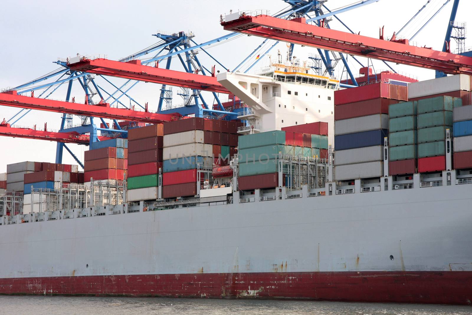 Tug boat with large container ship, Port of Hamburg on the river Elbe, the largest port in Germany