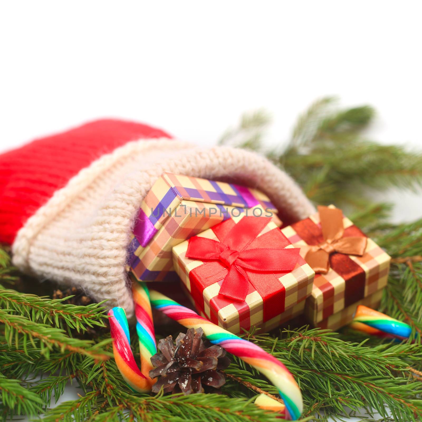 Red Christmas sock with gifts isolated on white background