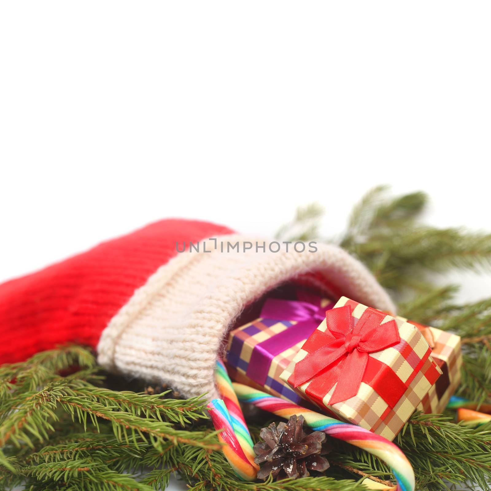 Red Christmas sock with gifts isolated on white background