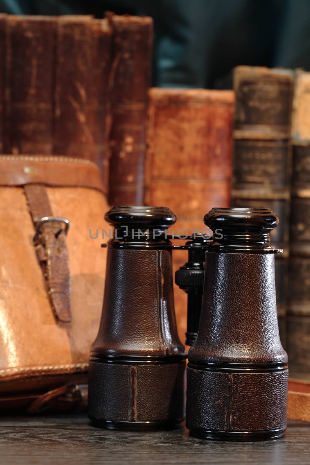 Vintage still life. Old binoculars near leather case