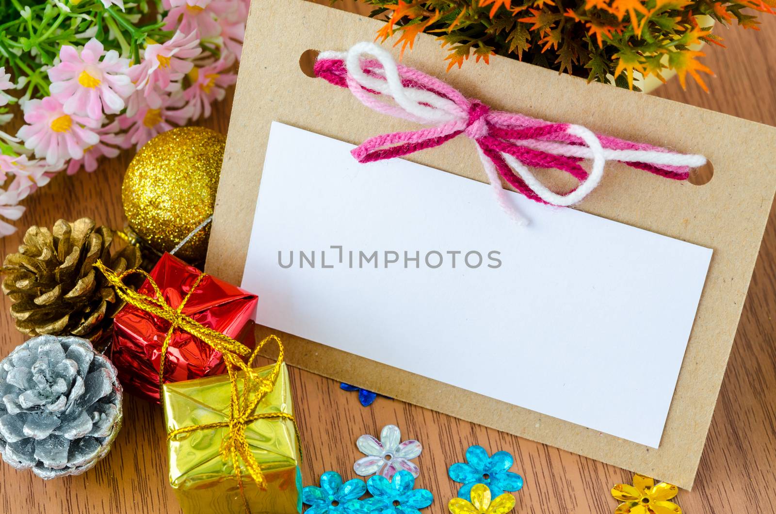 Blank Christmas Greeting card for your text with Christmas decorations with flower on wooden background.