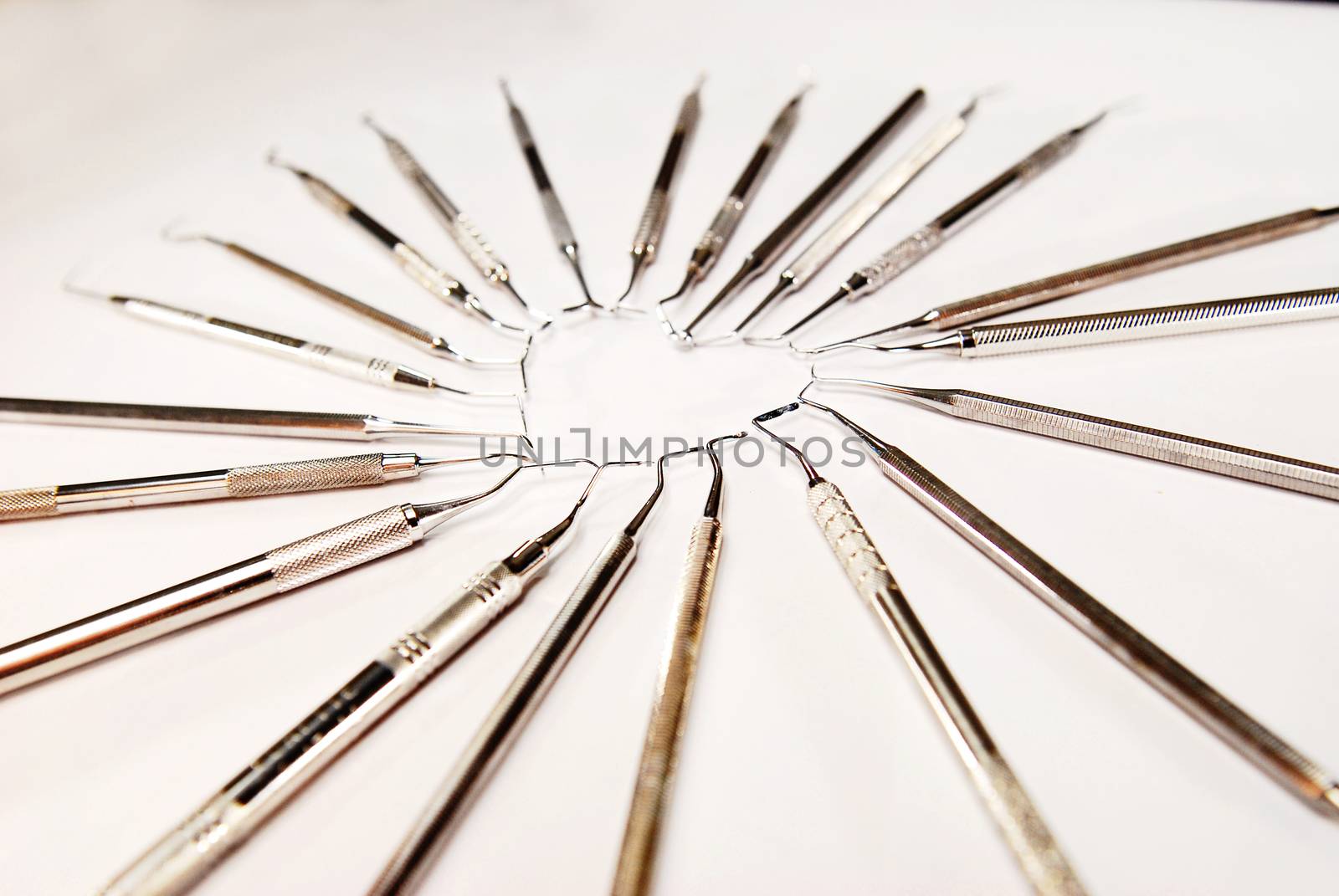 Dental instruments in heart shape on white background by Hepjam