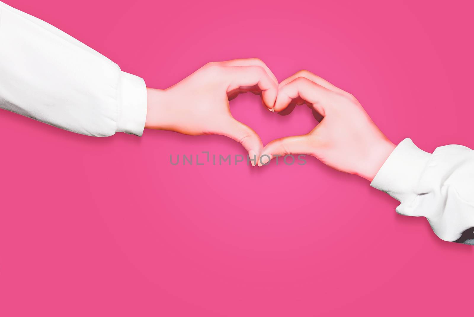 Hands in form of heart isolated on pink background, arms wearing long white sleeves by Hepjam