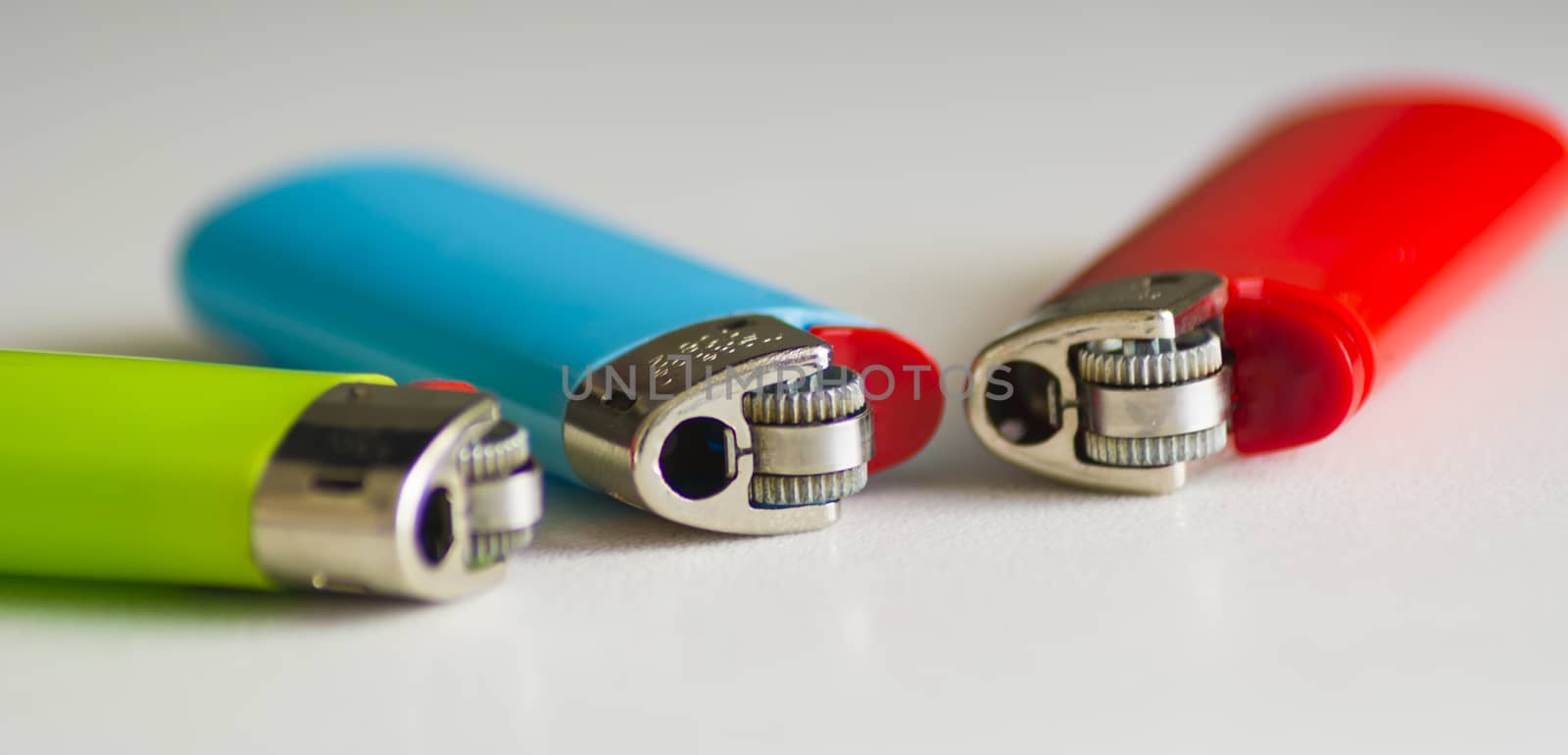 close up of three plastic lighters