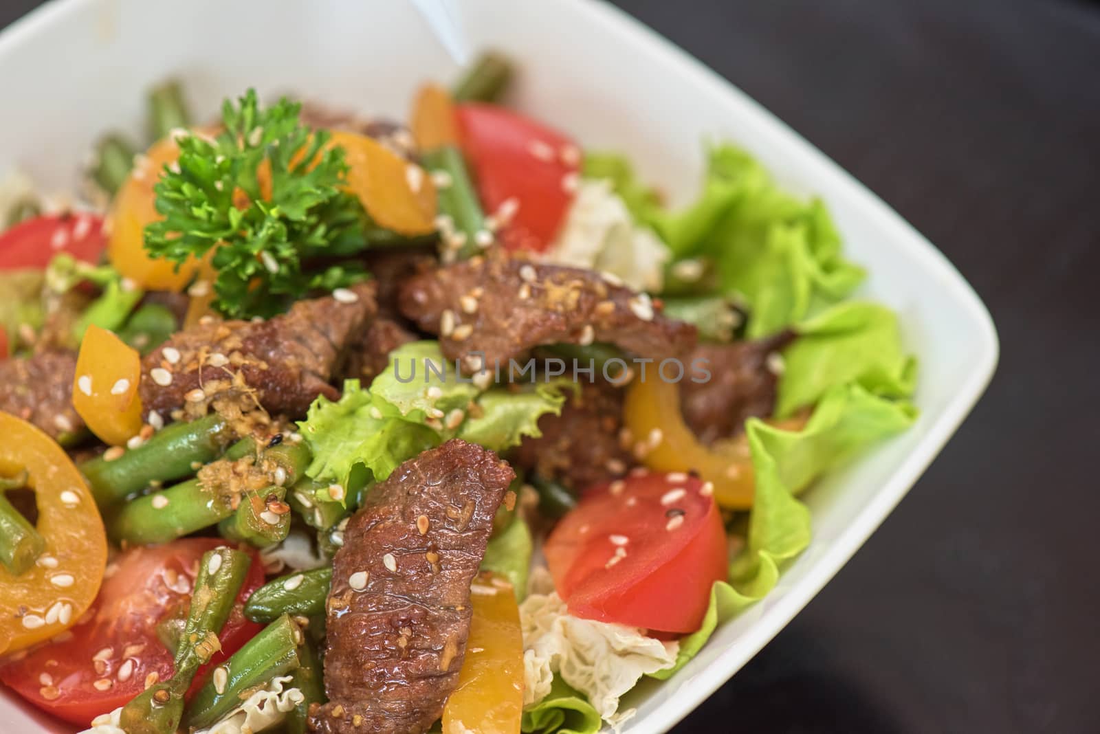 Warm salad with veal closeup