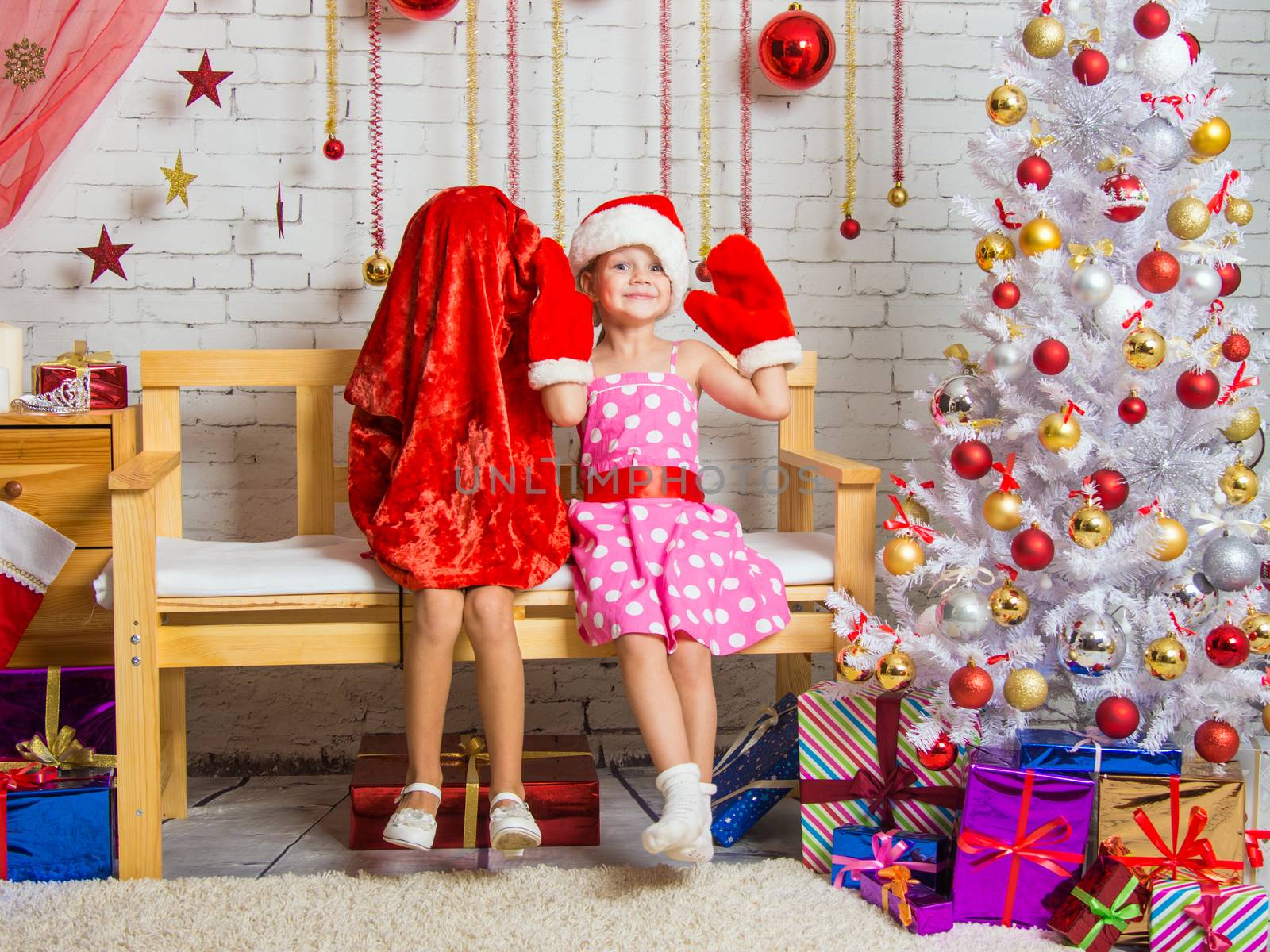 Two funny sisters four girls and six years of playing and having fun in the home New Years interior