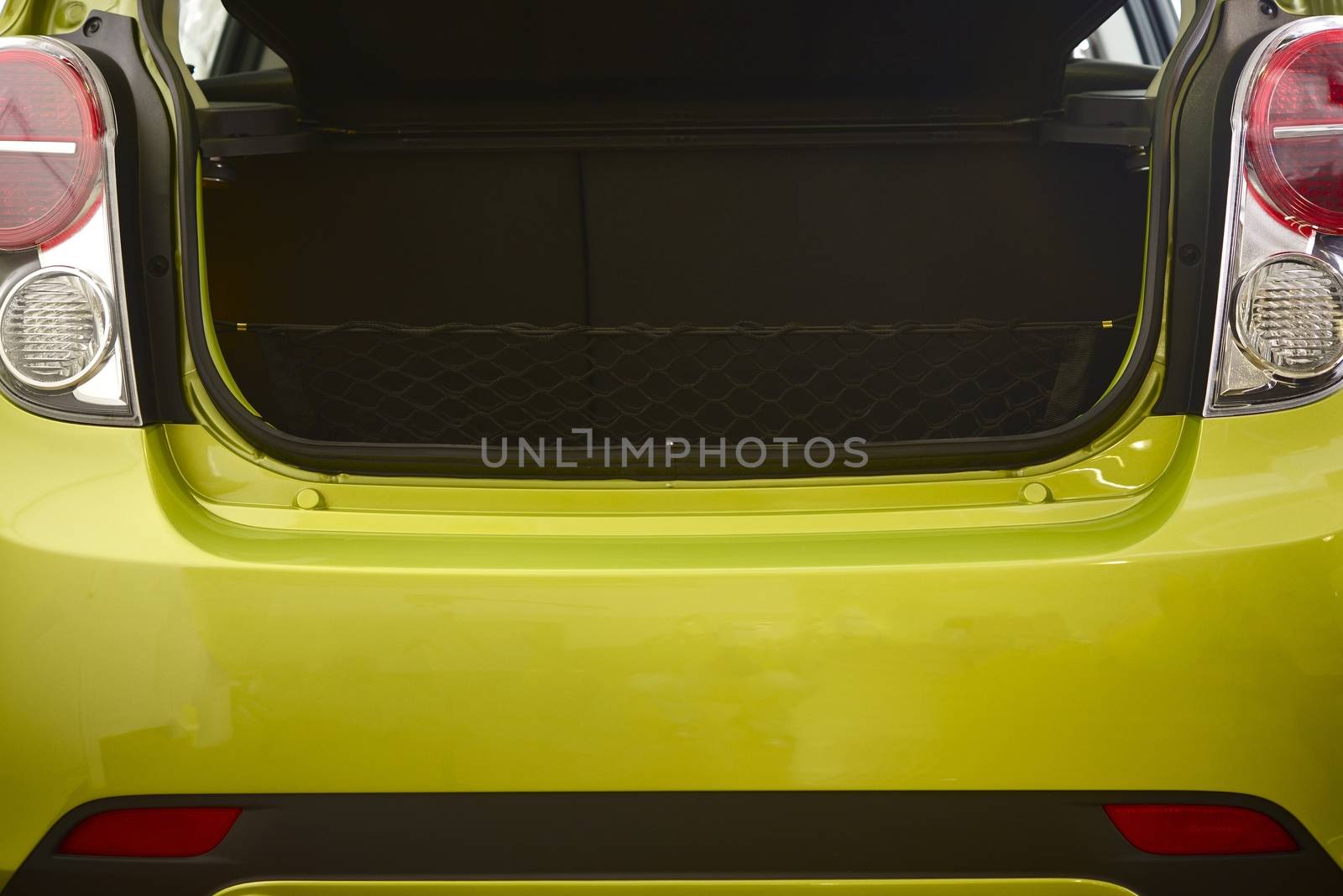 Compact Car Trunk Closeup Photo. Green Body Compact Vehicle.