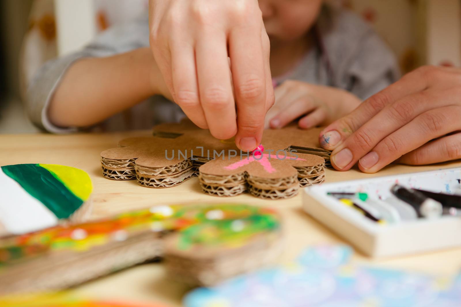 Little female baby painting with colorful paints by sarymsakov