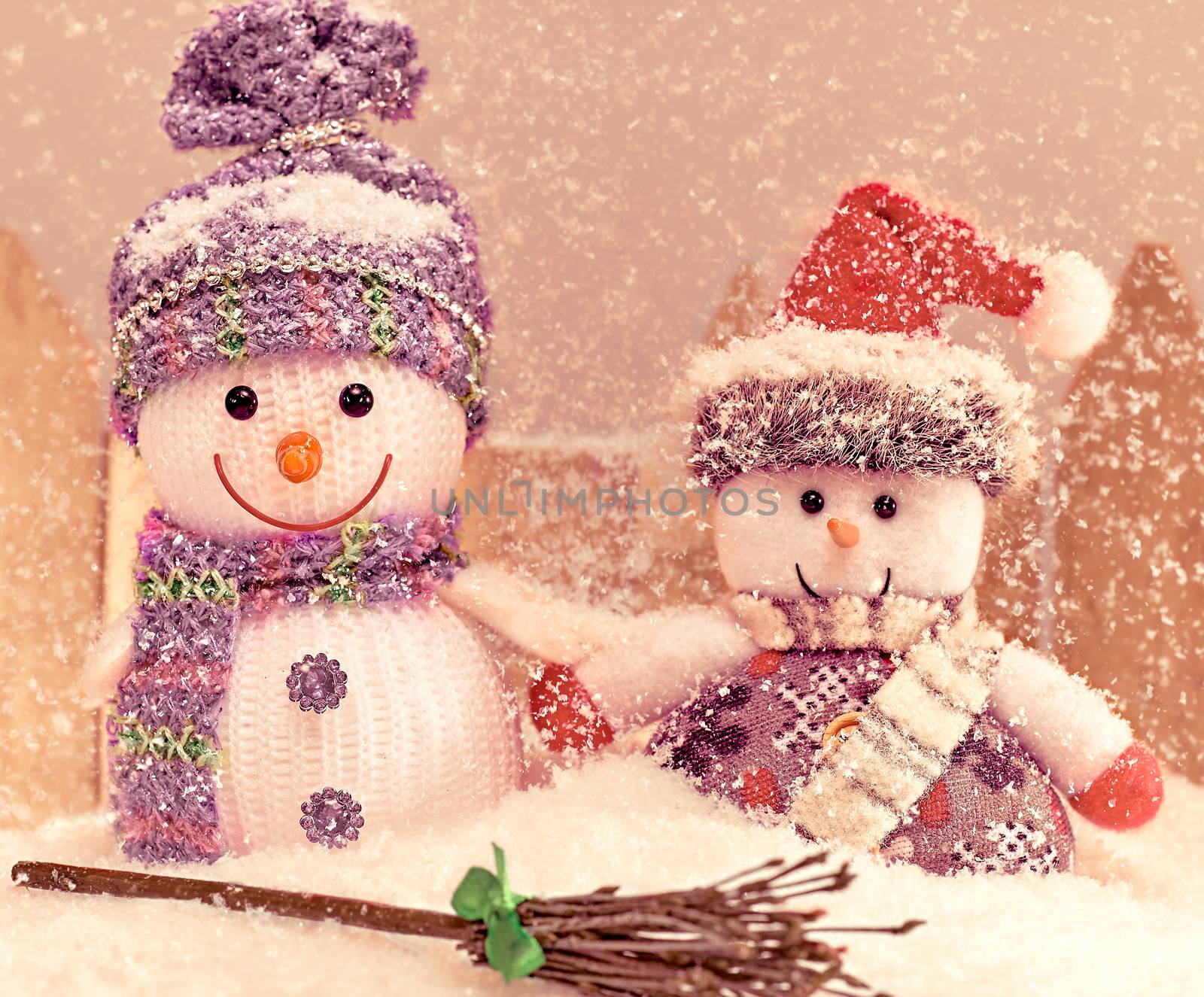 New Year 2016. Merry Christmas. Happy two snowman smiling, friendship on snow, in Santa hat with broom. Cheerful fun winter holiday celebration, snowfall. Retro, vintage, grain effect. Greeting card