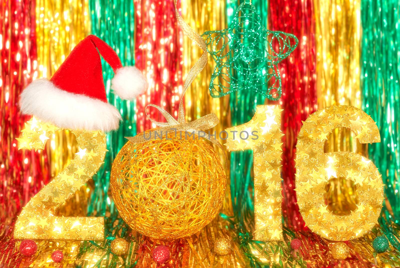 New Year 2016. Merry Christmas. Colorful handmade festive stars digits, ball, Santa hat , tinsel, bokeh. Shiny background. Vivid greeting card, happy celebration. Party decoration, green red gold