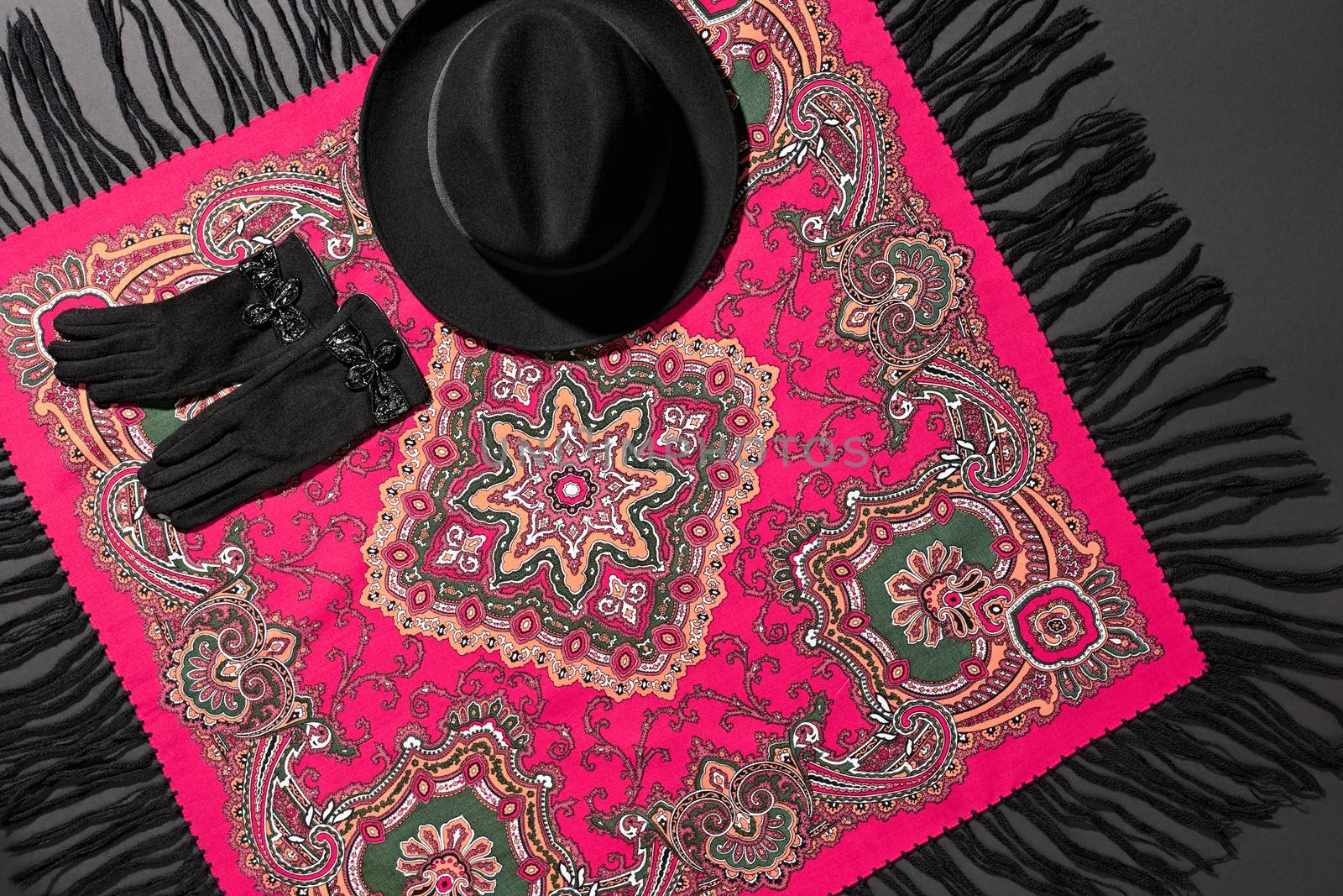 Fashion clothes stylish set, colored shawl and accessories. Ethnic traditional pattern pink cashmere, wool headscarf, trendy black hat, gloves. Unusual creative elegant. Autumn winter. Vintage retro