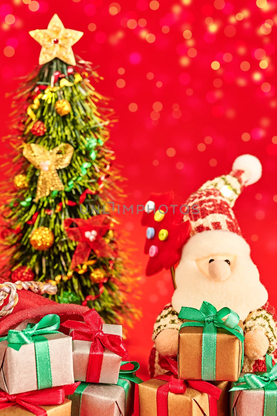 New Year 2016. Merry Christmas. Cute Santa Claus with Christmas tree and big sack of presents, handmade on red, bokeh. Happy cheerful traditional holiday. Vivid greeting card, multicolored, copyspace