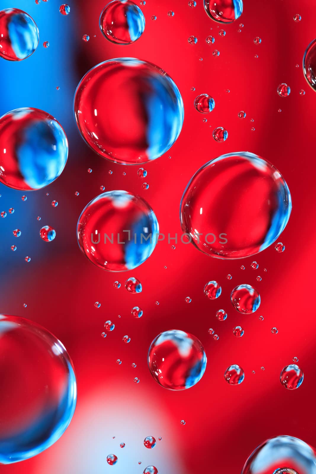 Abstract red and blue background with various water drops